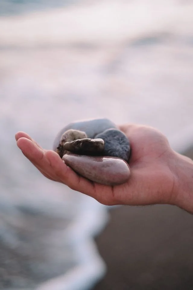hand holding smooth stones