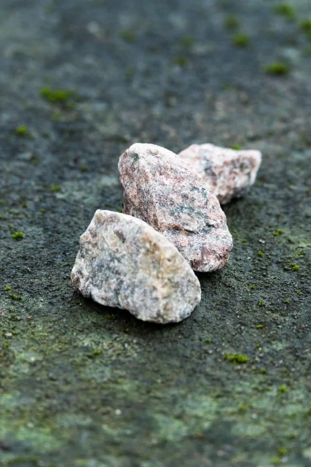 white and pink stones on a green ground