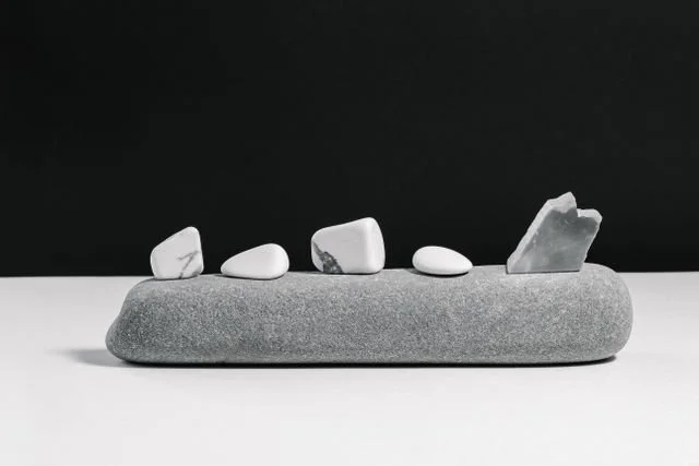 small stones lined up on a longer stone