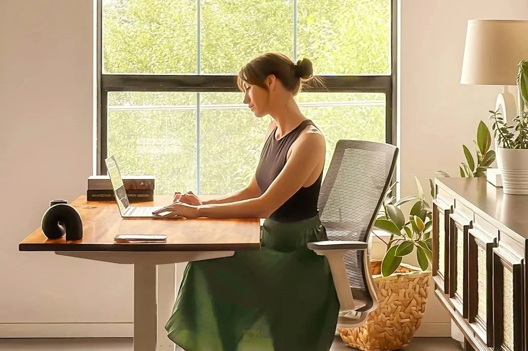 Professional woman working thoughtfully at desk representing high-functioning anxiety in high-achieving women