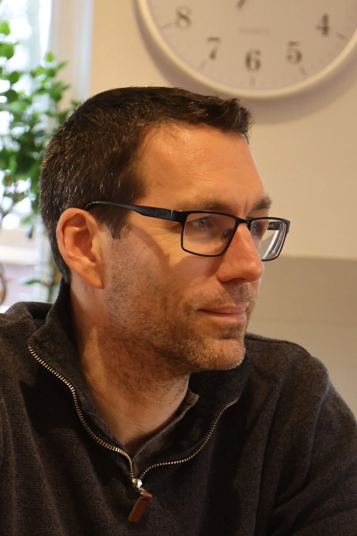 Ben Marsh - man with glasses wearing a brown quarter zipped top