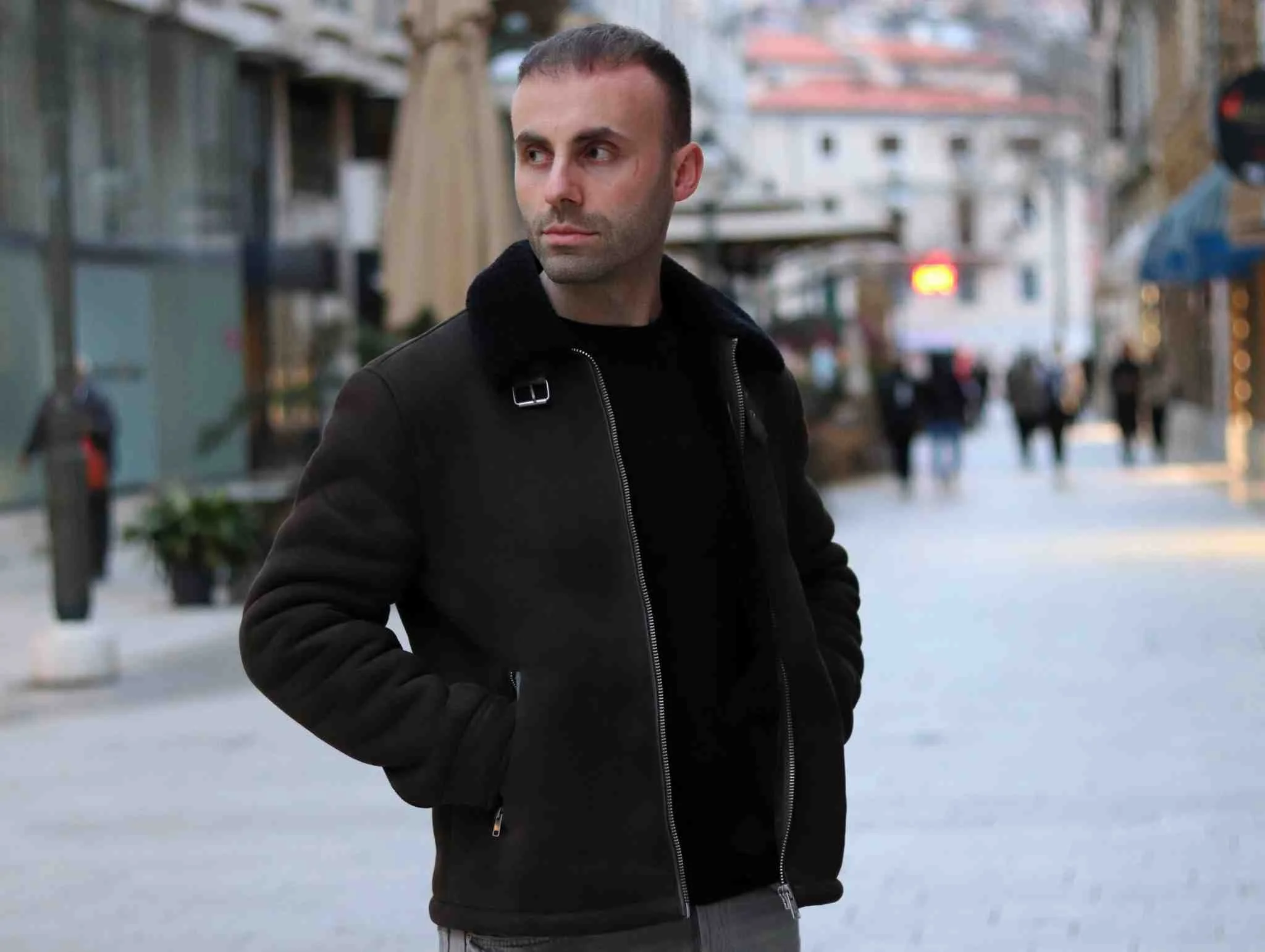 iain myles stood in middle of quiet street with good posture