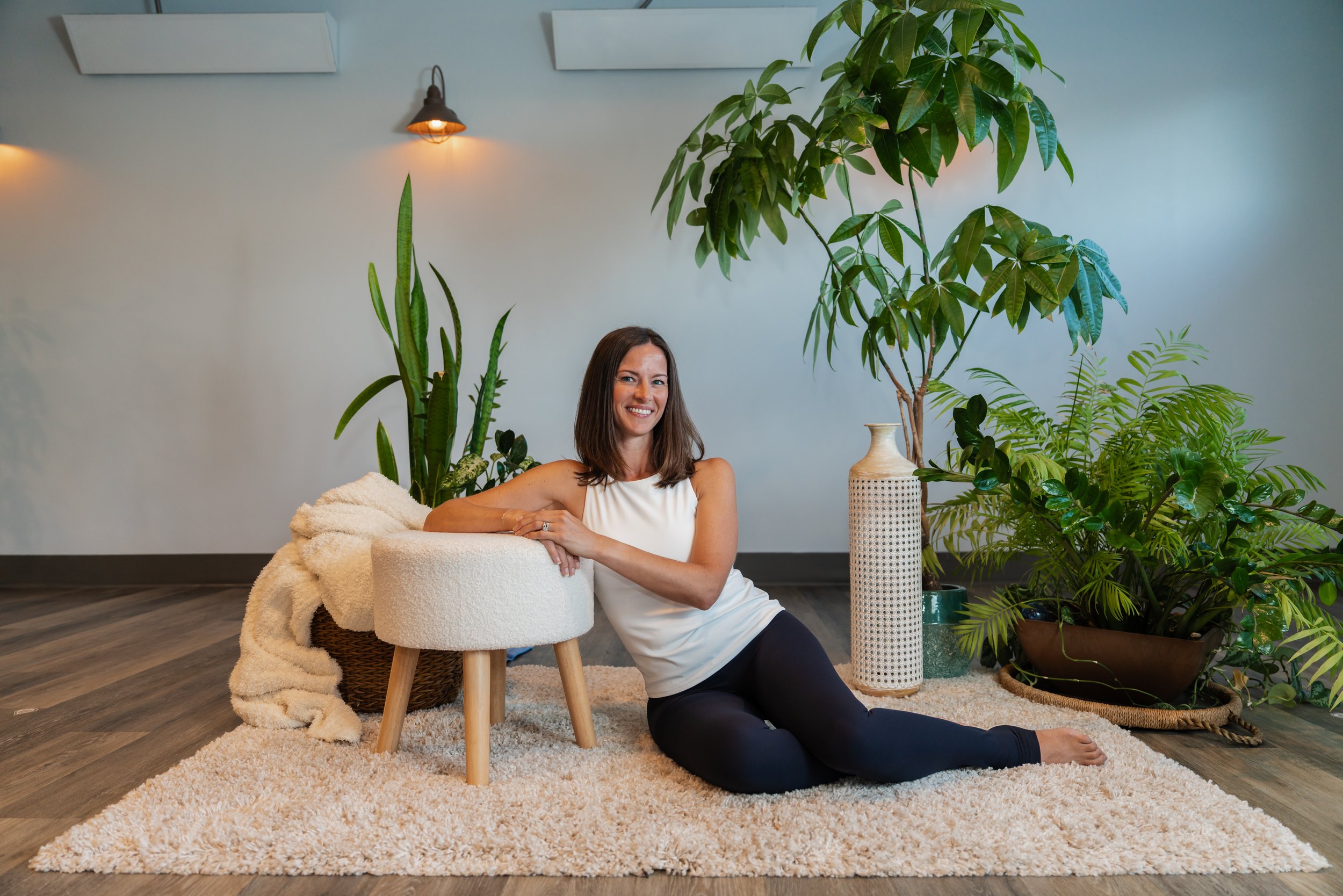 Connie Vrijenhoek sitting on a cushion with a welcoming smile