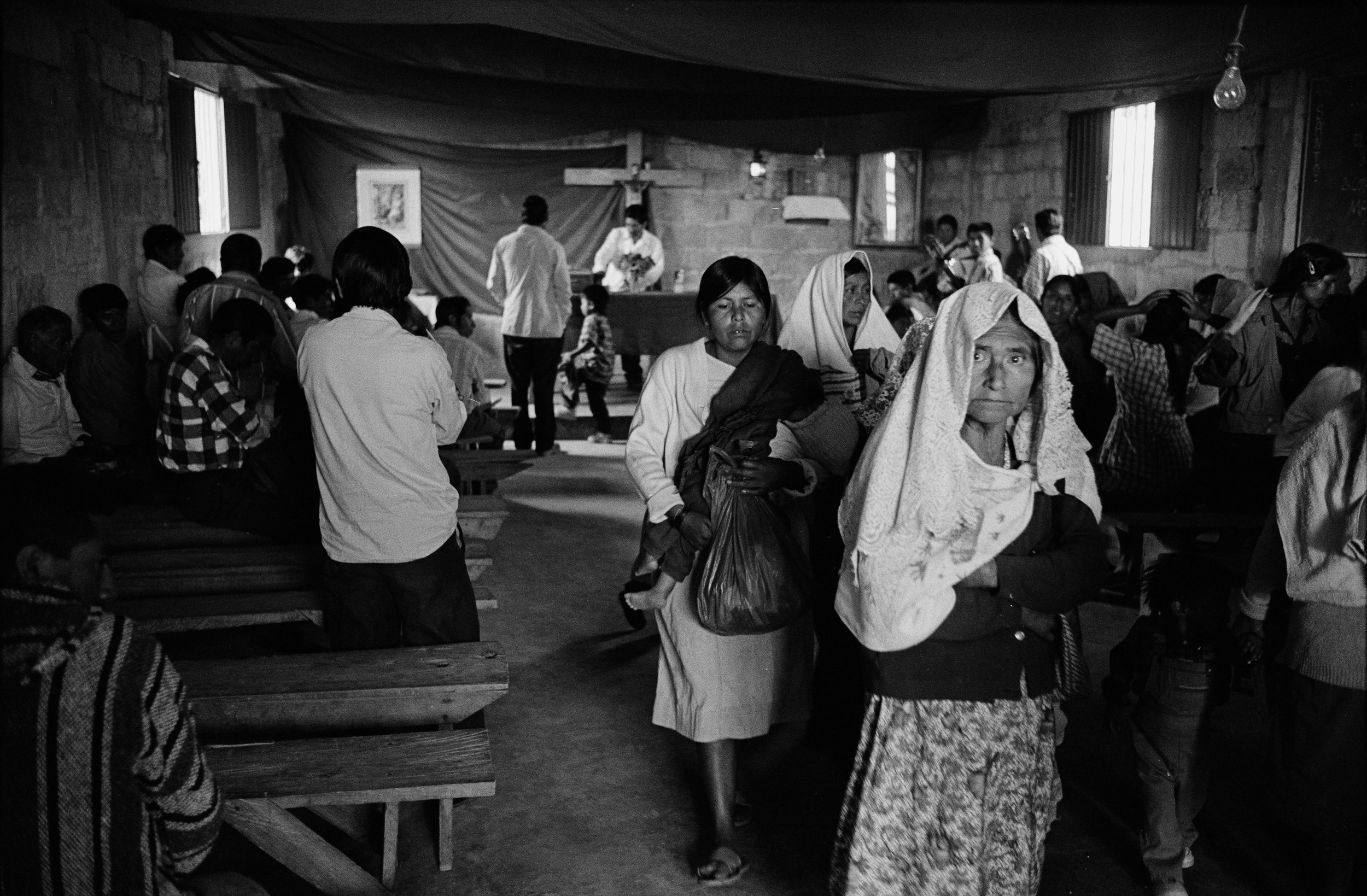  Residents of Rancho Bonito, high in the mountains of Chiapas, Mexico, leave church on Sunday morning in 2000. 