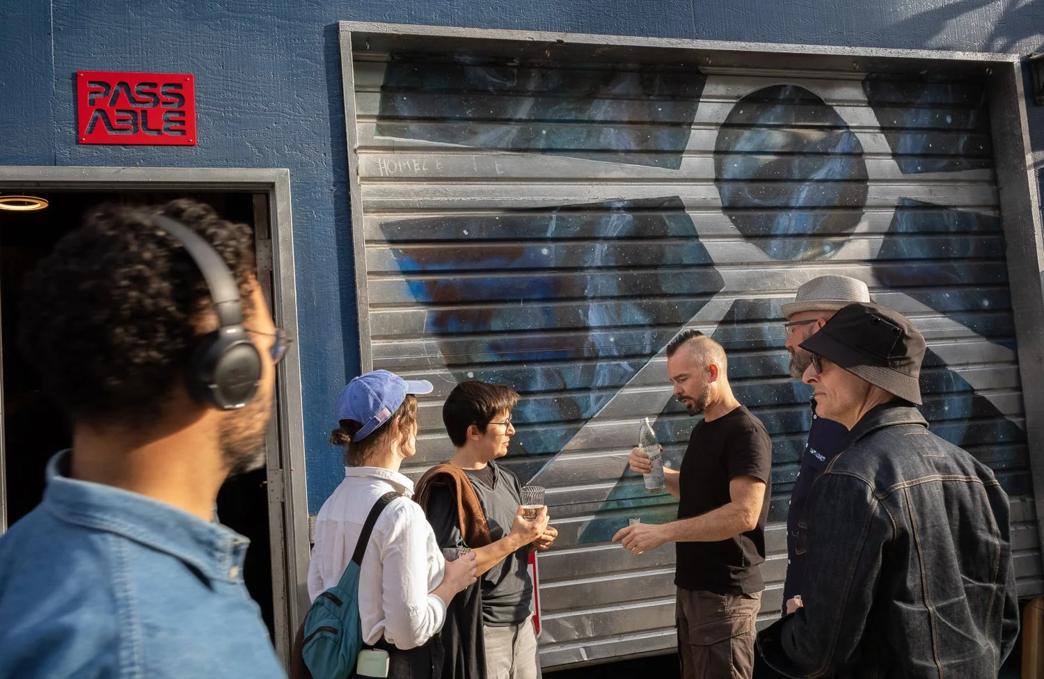  Levi Clark (black t-shirt) chats outside Passable, a collective studio space on Capitol Hill in Seattle, Washington, USA on June 13, 2024. 