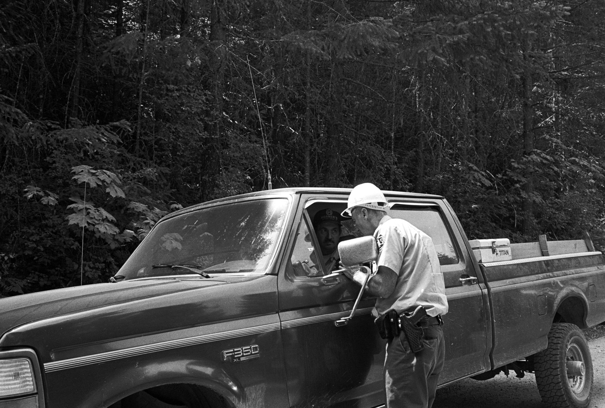 Logger and US Forest Service officer at a contested timber sale in Oregon, USA in 2003.