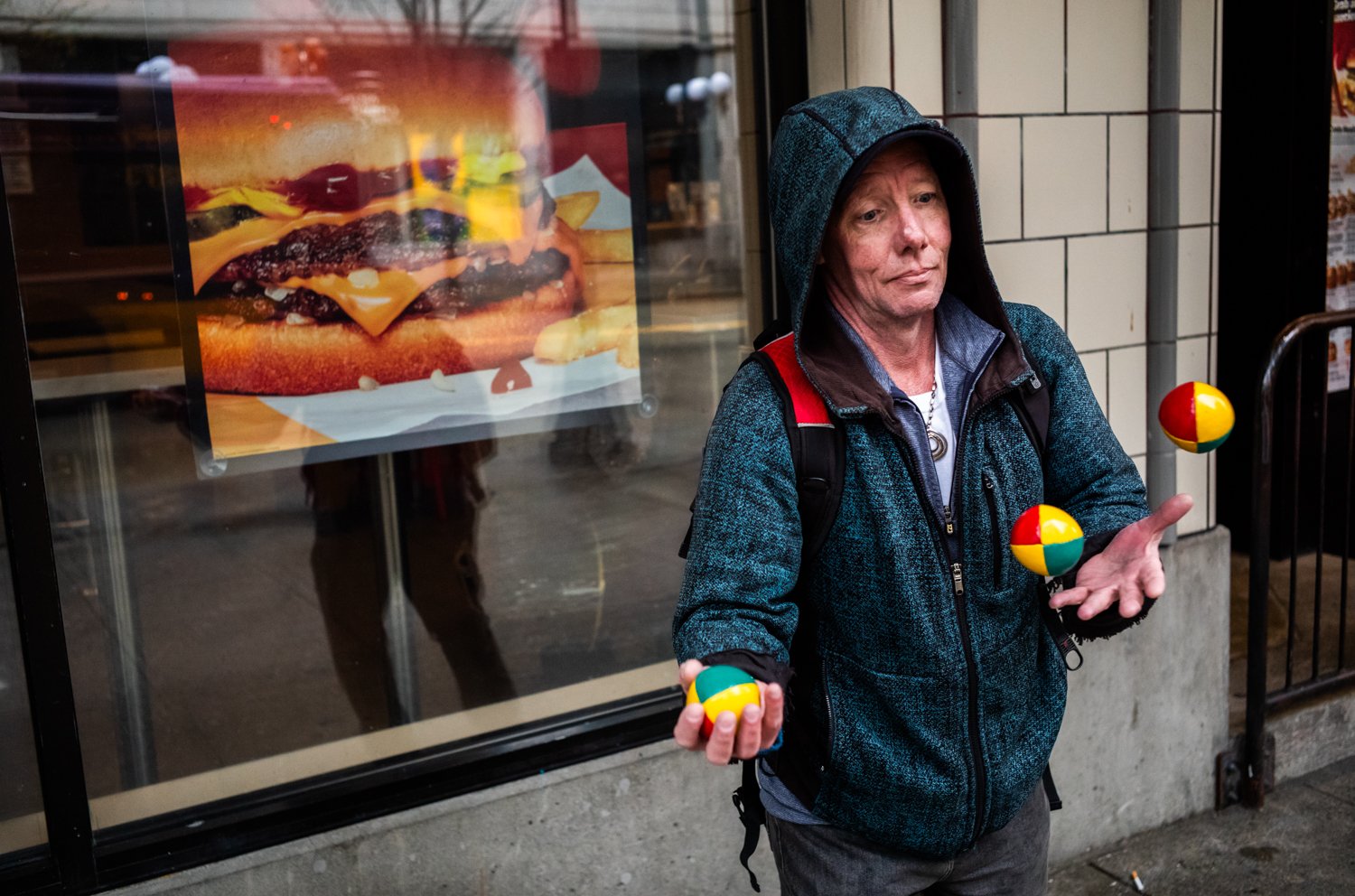 Dave juggles near McDonald’s on The Blade at 3rd Avenue and Pine Street in Seattle, Washington, USA on April 21, 2023.