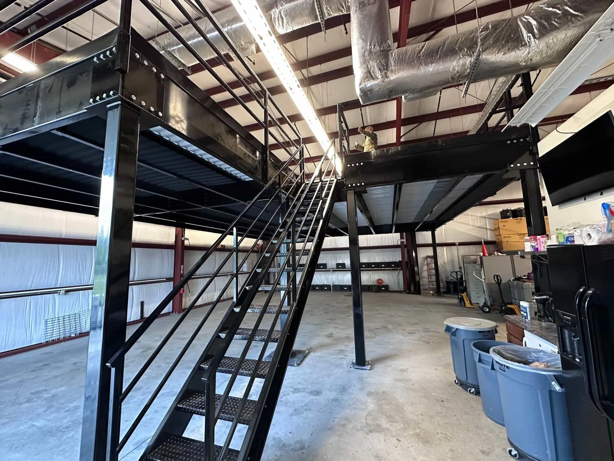 Industrial steel mezzanine and stair system installed inside a commercial facility