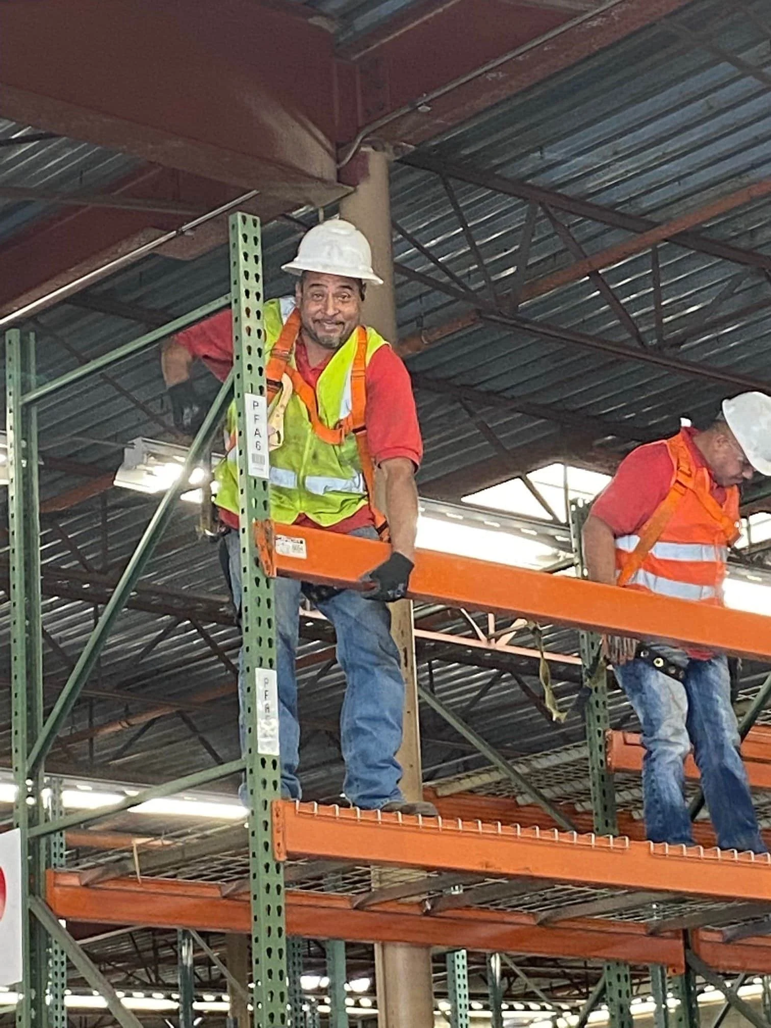 American Erecting installation crew assembling commercial pallet racking in a warehouse