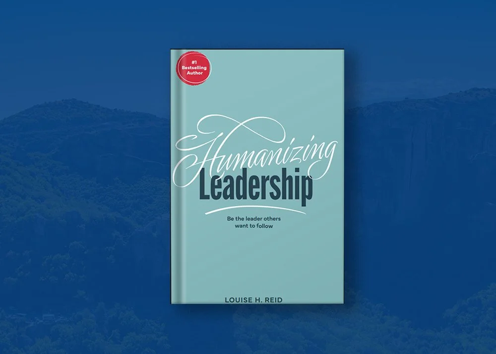 Cover of a book titled 'Humanizing Leadership' by Louise H. Reid, with a red badge indicating it is a #1 bestselling author, against a blue background with mountains.