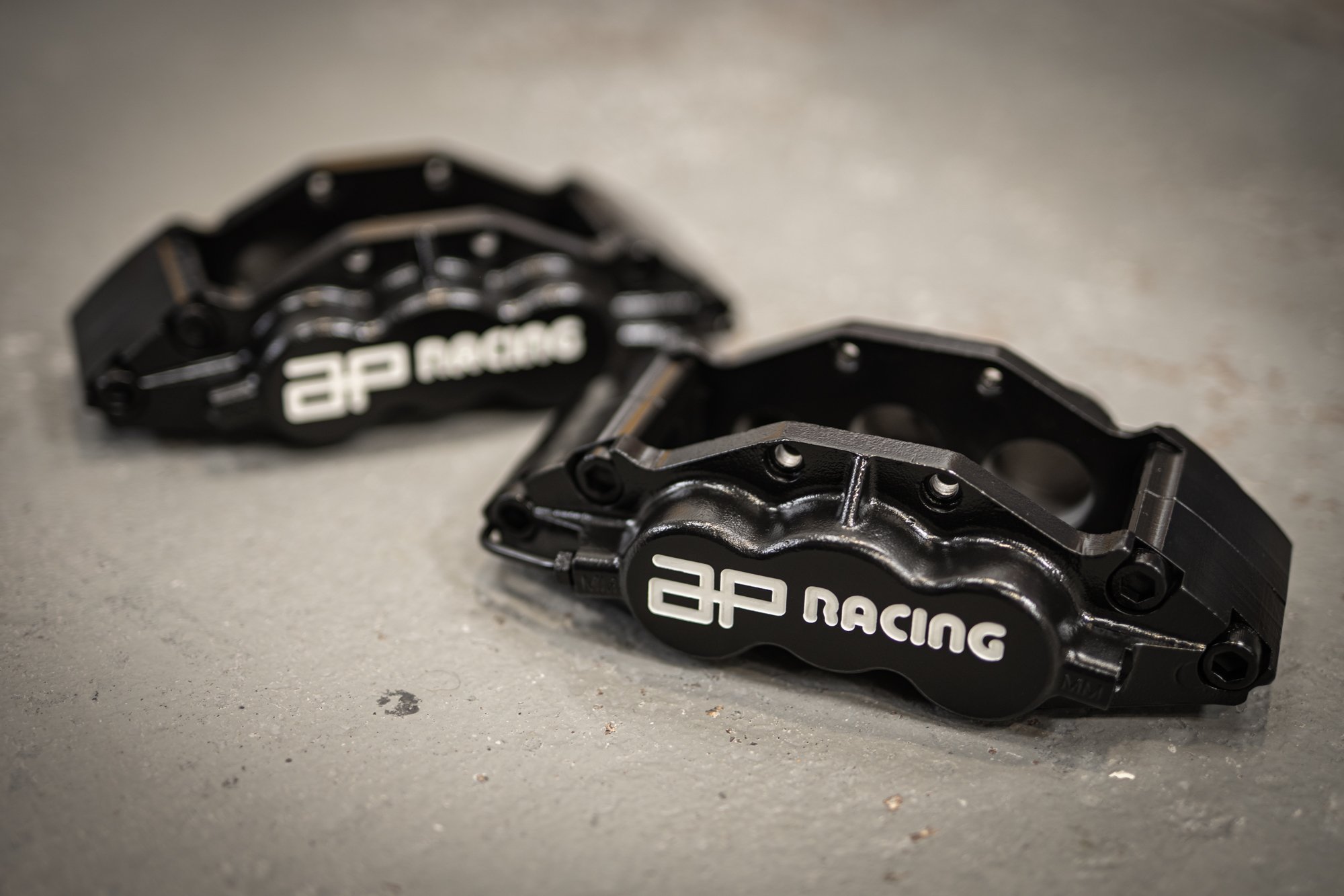 AP Racing 6 pot brakes in Graphite Black with Bright White infill, sealed with High Gloss Clear 
