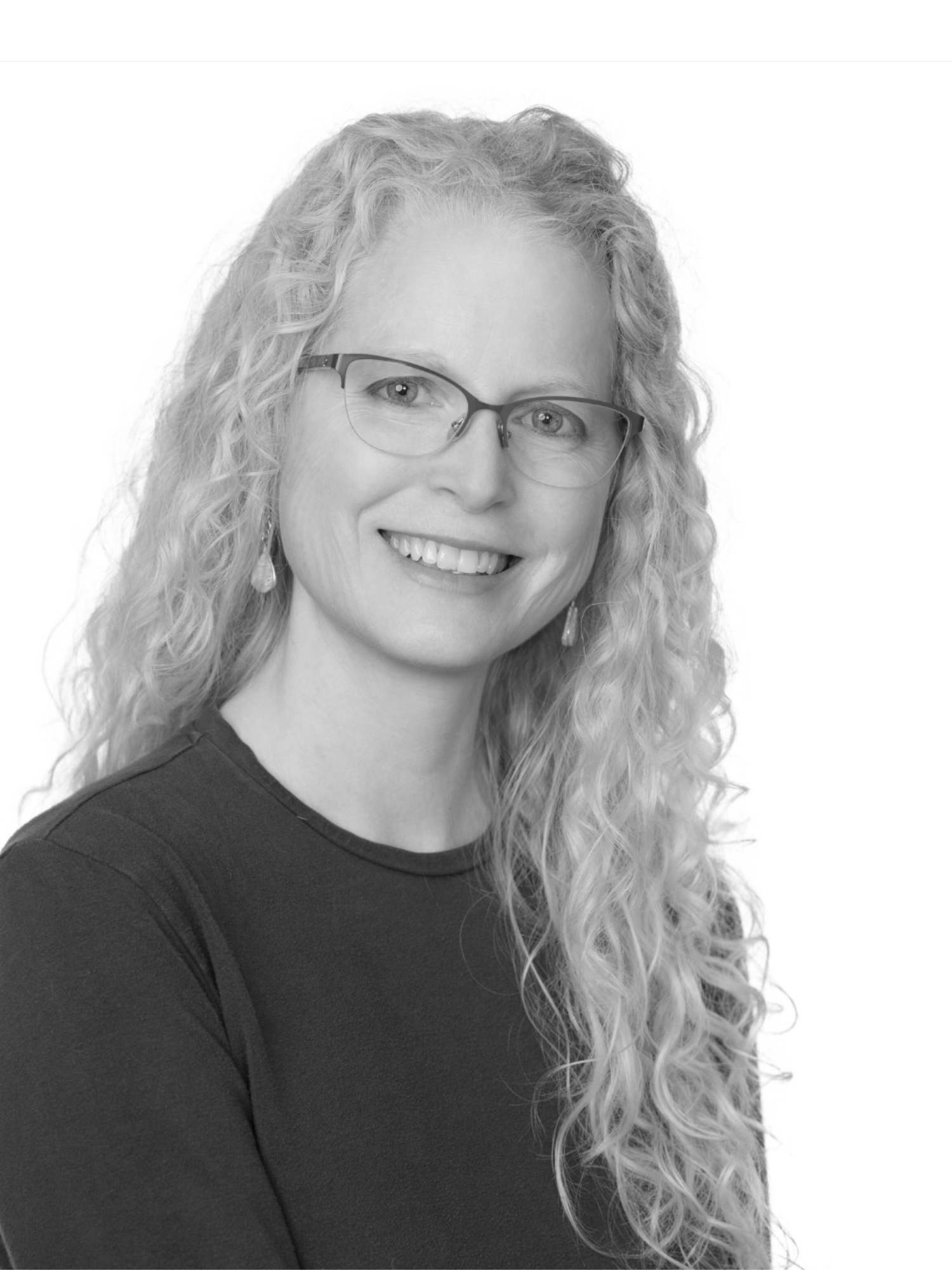 Author Louise M. Aamodt's photo, black and white, wearing glasses.