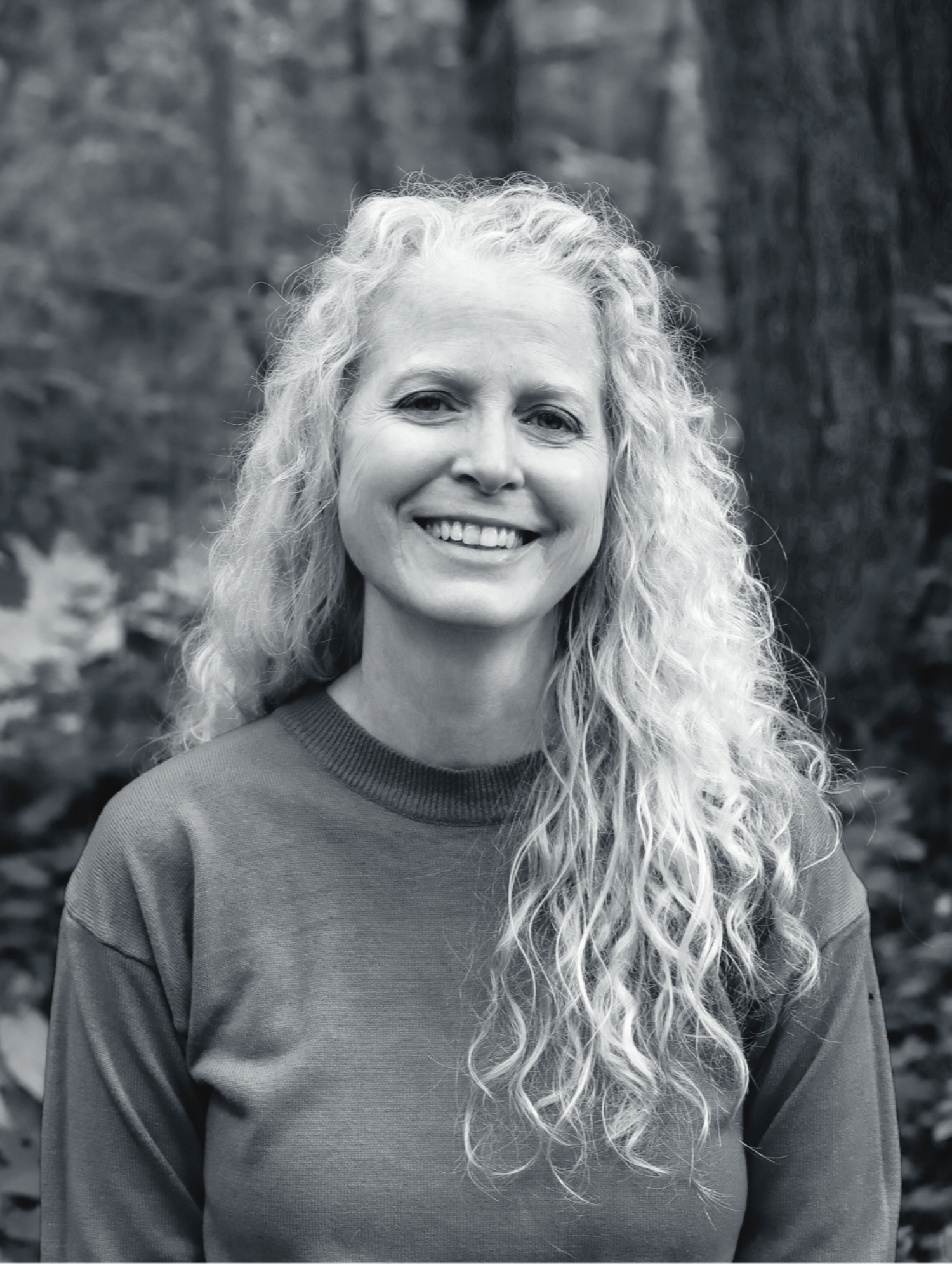 Author Louise M. Aamodt's photo, outside, black and white, without glasses.