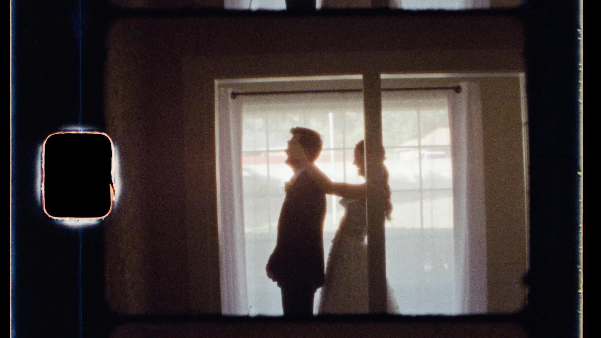 a woman walks up to her fiance and holds her hands in front of his eyes. They are about to do their first look before their ceremony.