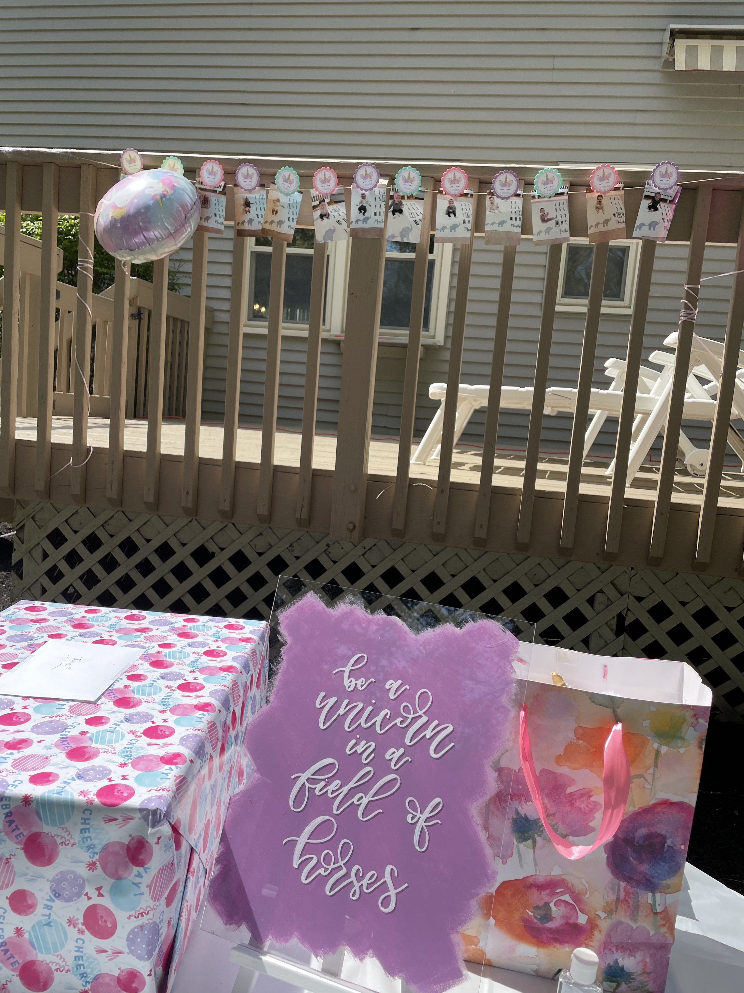 Enchanting first birthday sign featuring playful calligraphy, celebrating the magical unicorn theme with vibrant colors and whimsical details.
