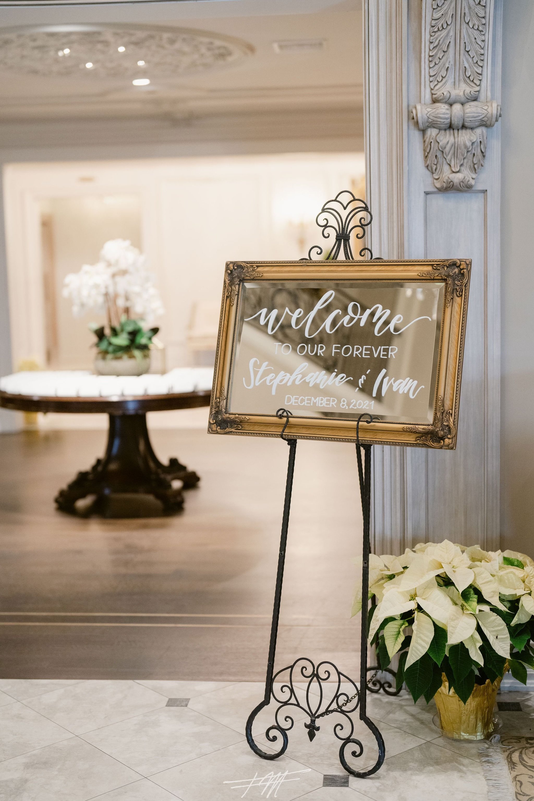 a chic and elegant wedding welcome sign at an upscale wedding venue