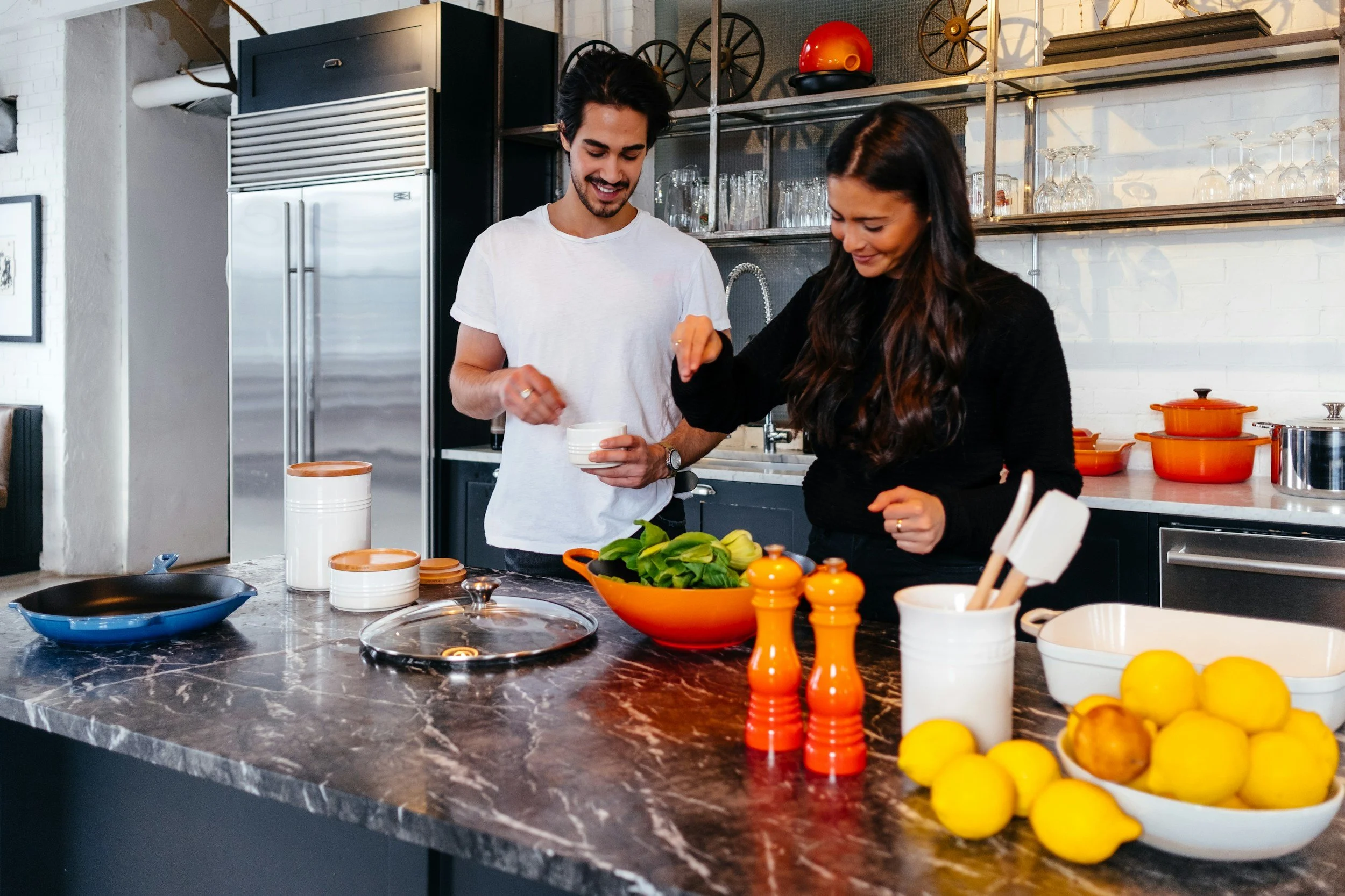 A latino couple meal prepping in the kitchen together