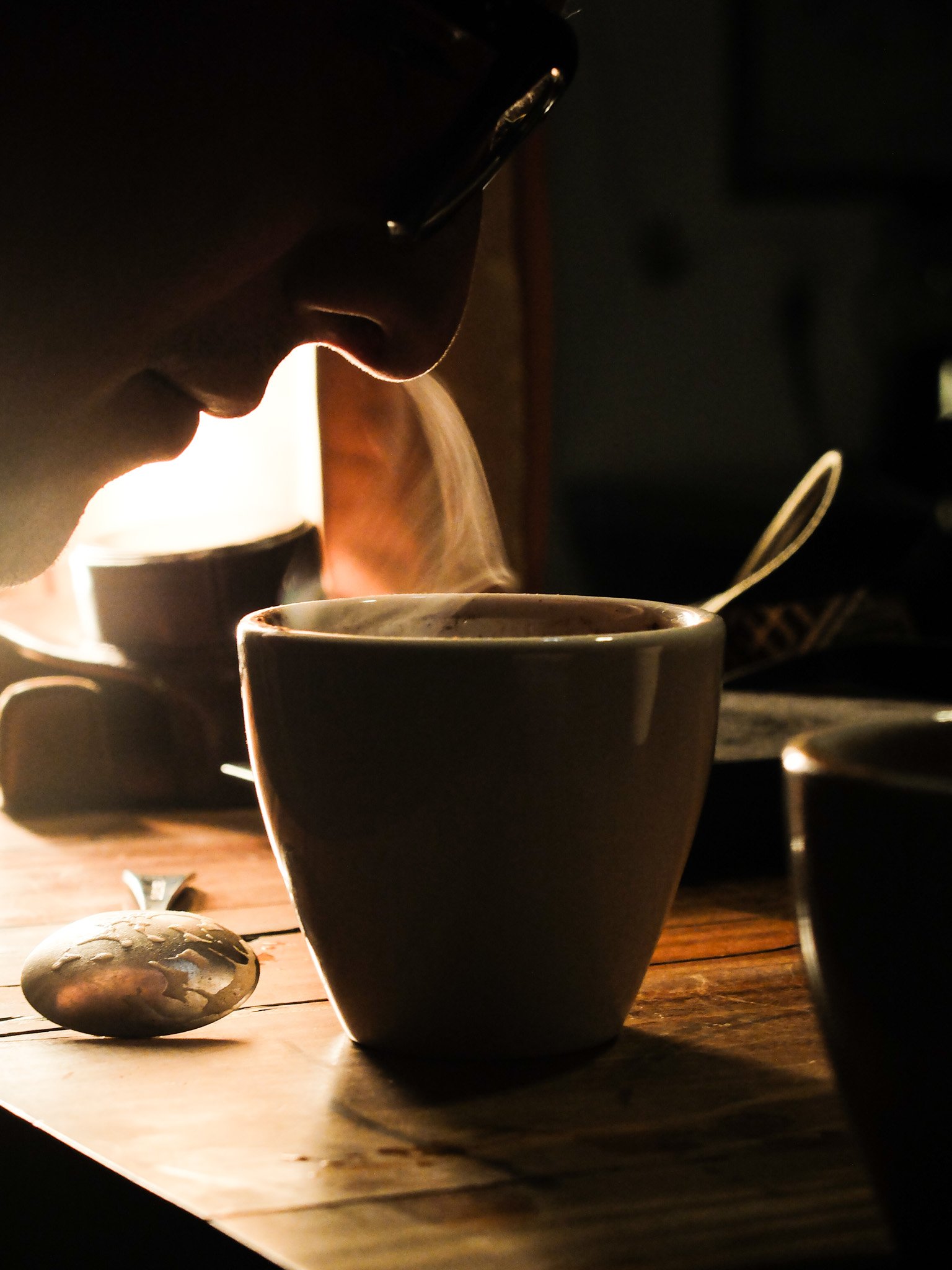 Smelling the aroma of the coffee on the cupping bowl. This is the way specialty coffee roasters evaluate their coffee profiles.