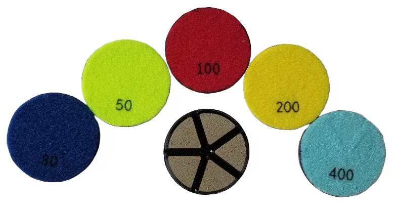Colorful polishing pads with grit numbers, including black pad with segment design.