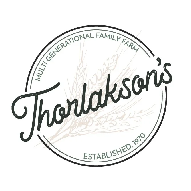 Logo for Tharlakson's Multi-Generational Family Farm established in 1970, featuring a stylized wheat graphic.
