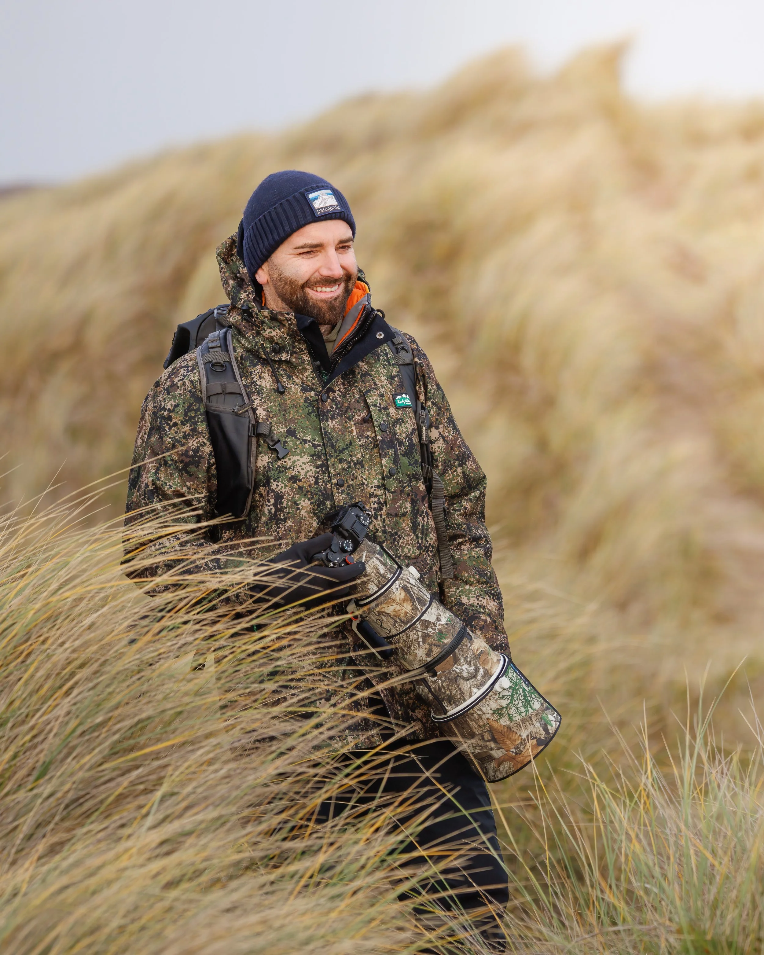 Wildlife photographer Adam Thomas capturing seals from the dune path at Horsey