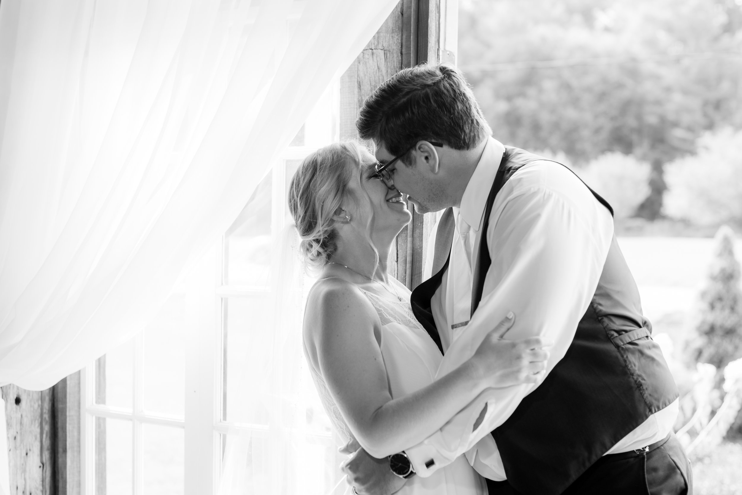 black and white photo of an Upstate NY wedding couple about to kiss