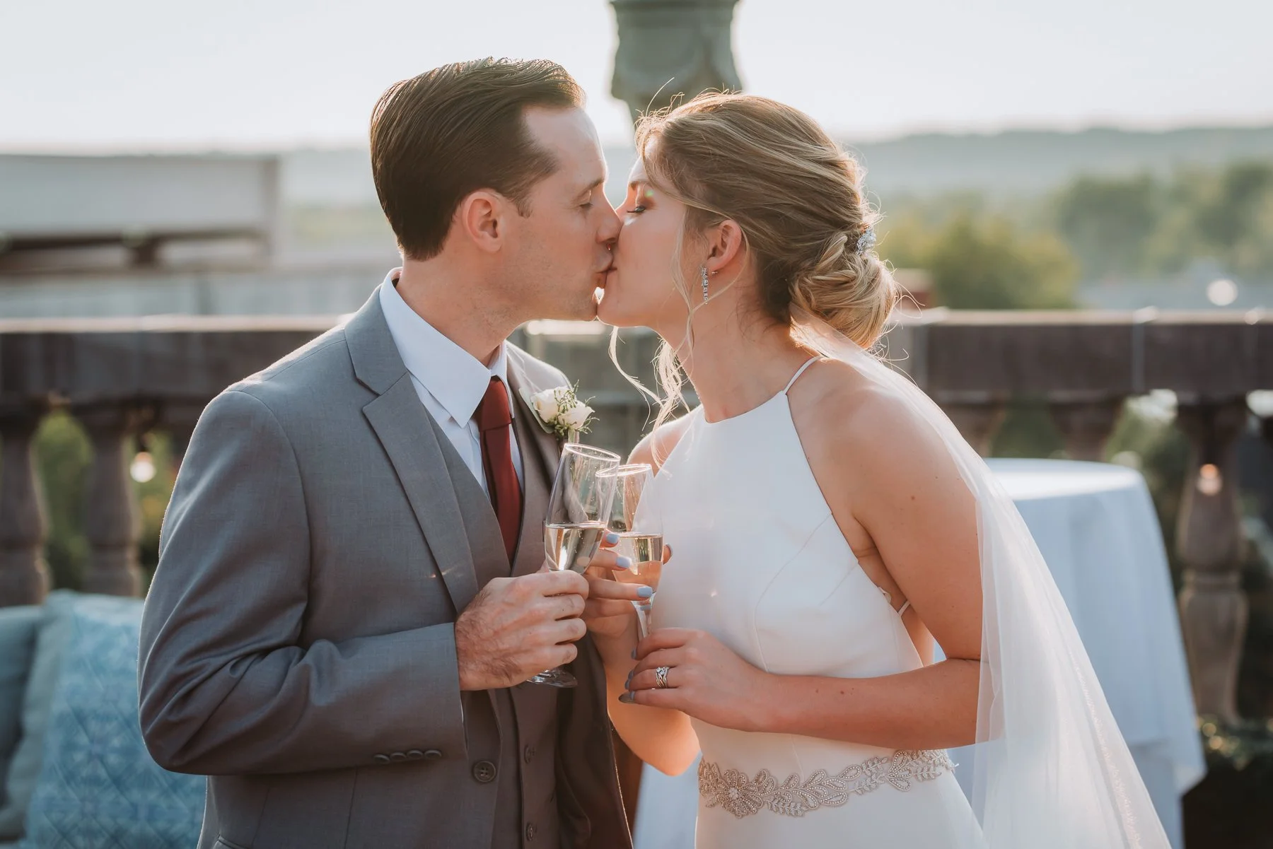 Upstate New York Wedding Couple kissing  and holding champagne