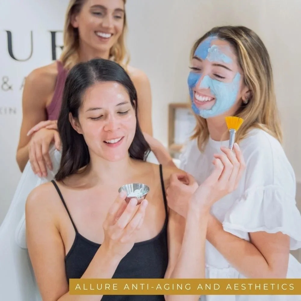 Branding photograph for a medical spa: three women laughing during a face-mask treatment.