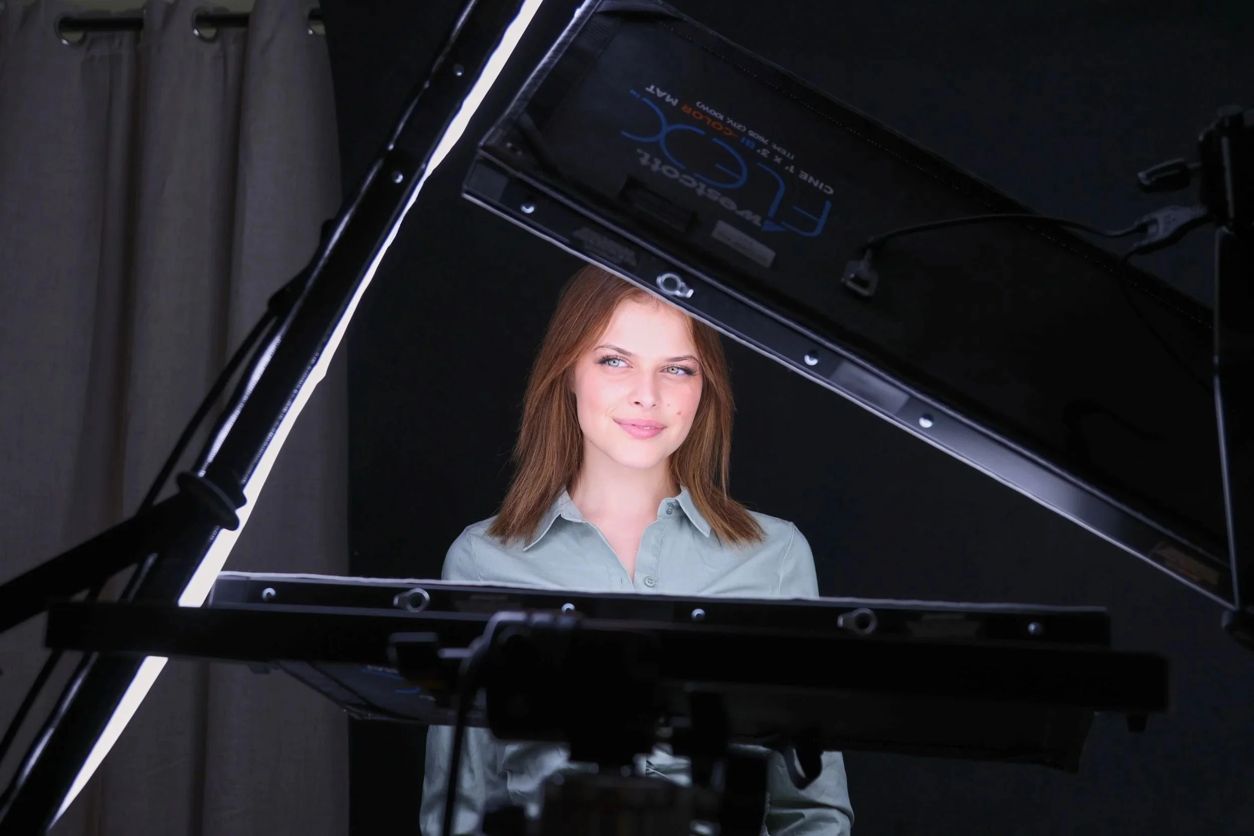 Behind the scenes in the Irvine studio: a client lit by a large overhead softbox during a headshot session.