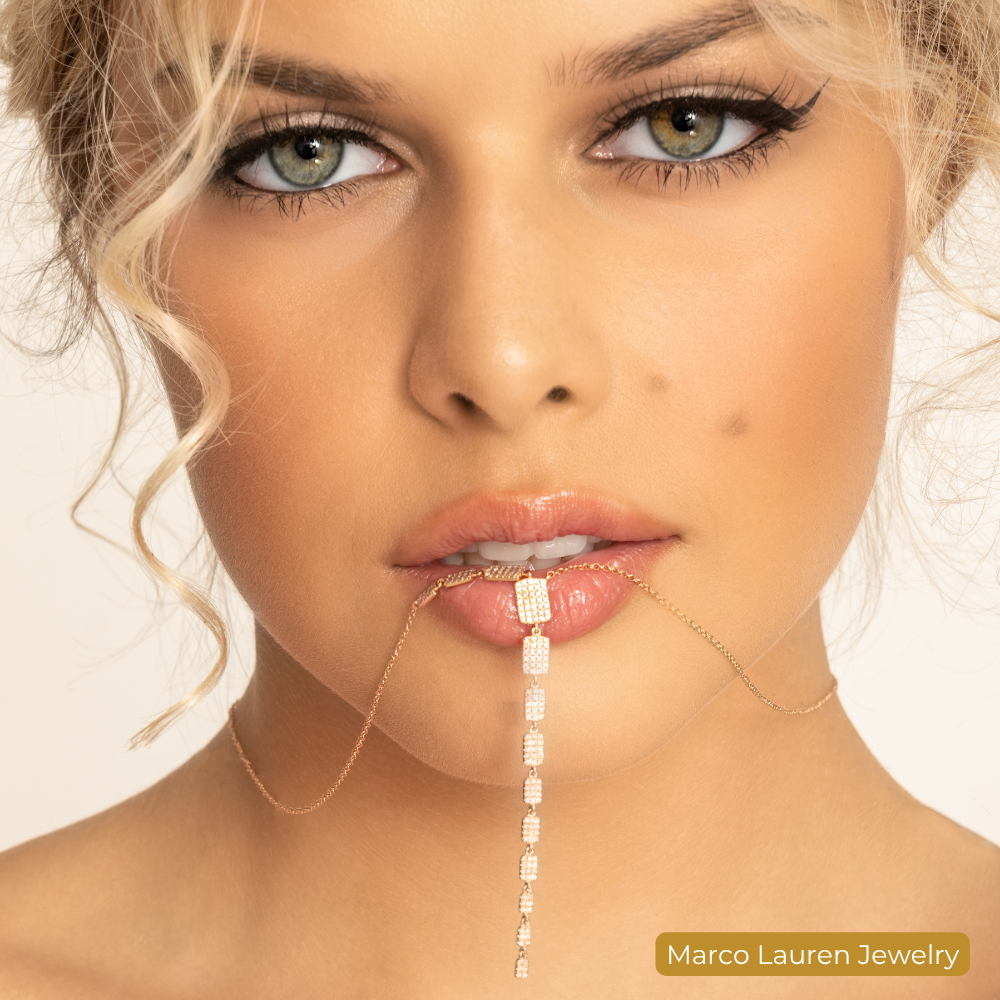 Branding photograph for a jewelry label: a close-up of a model wearing a fine gold chain.