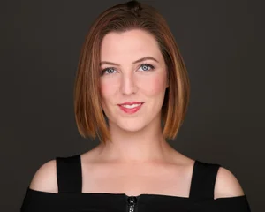 Headshot of a woman with auburn hair