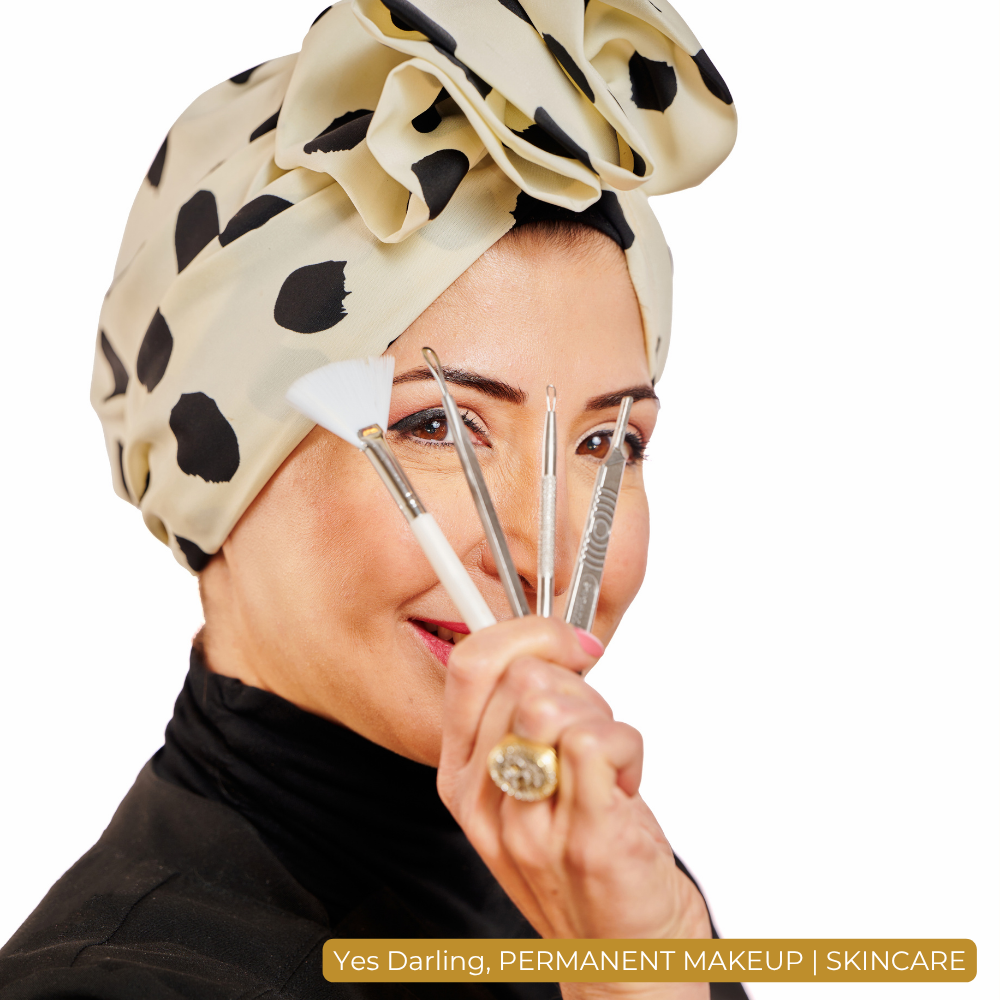 Branding photograph for a permanent-makeup studio: an artist in a printed headwrap holding her brow tools.