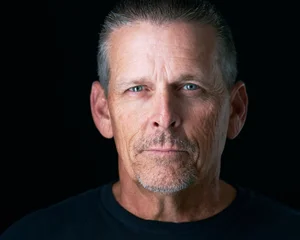 Headshot of a man on a black background