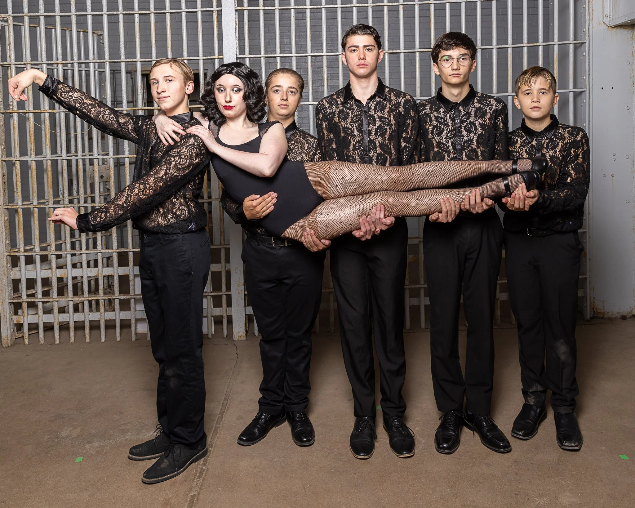 Five boys hold a girl in the air
