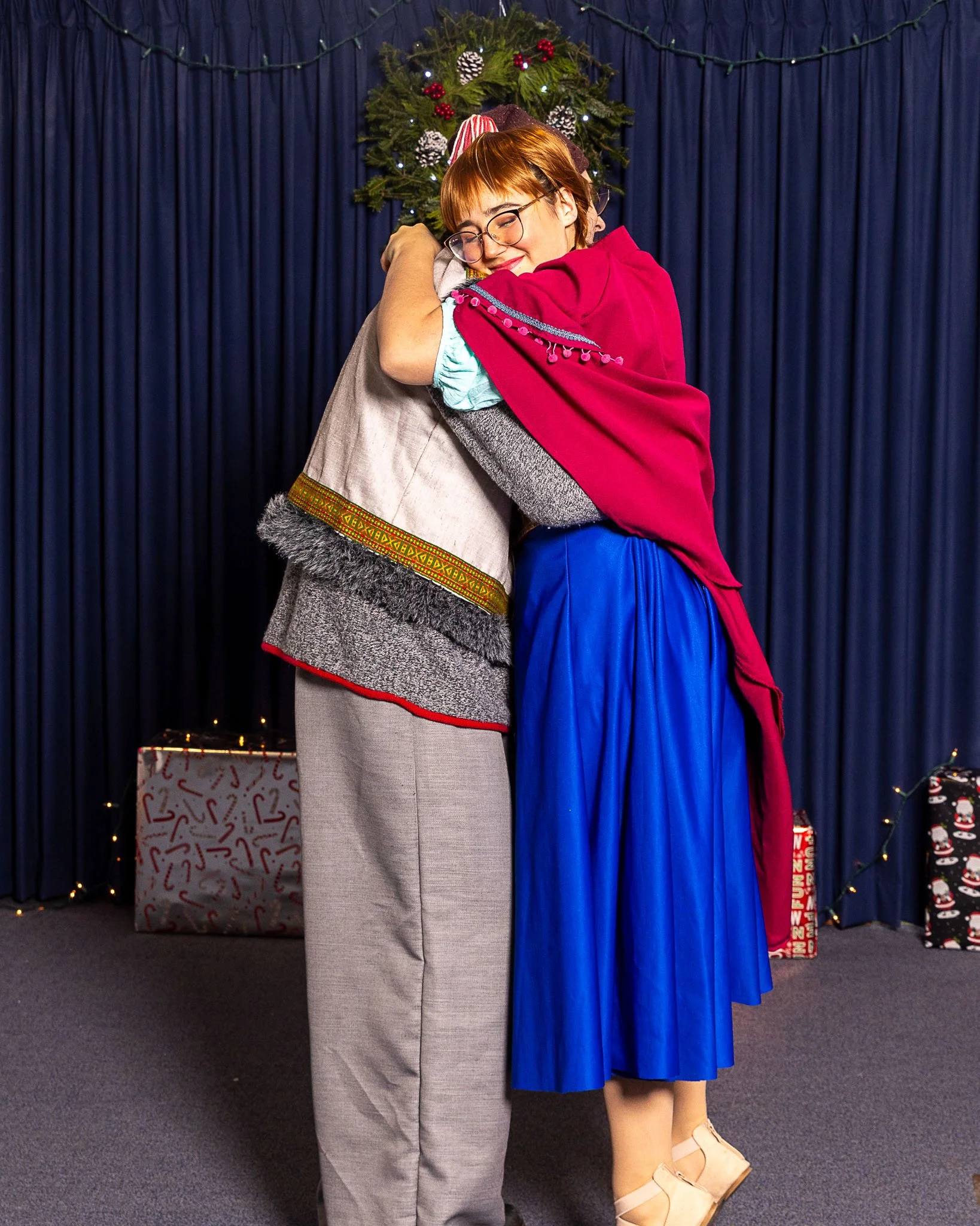 Actors playing Kristoff and Anna embrace
