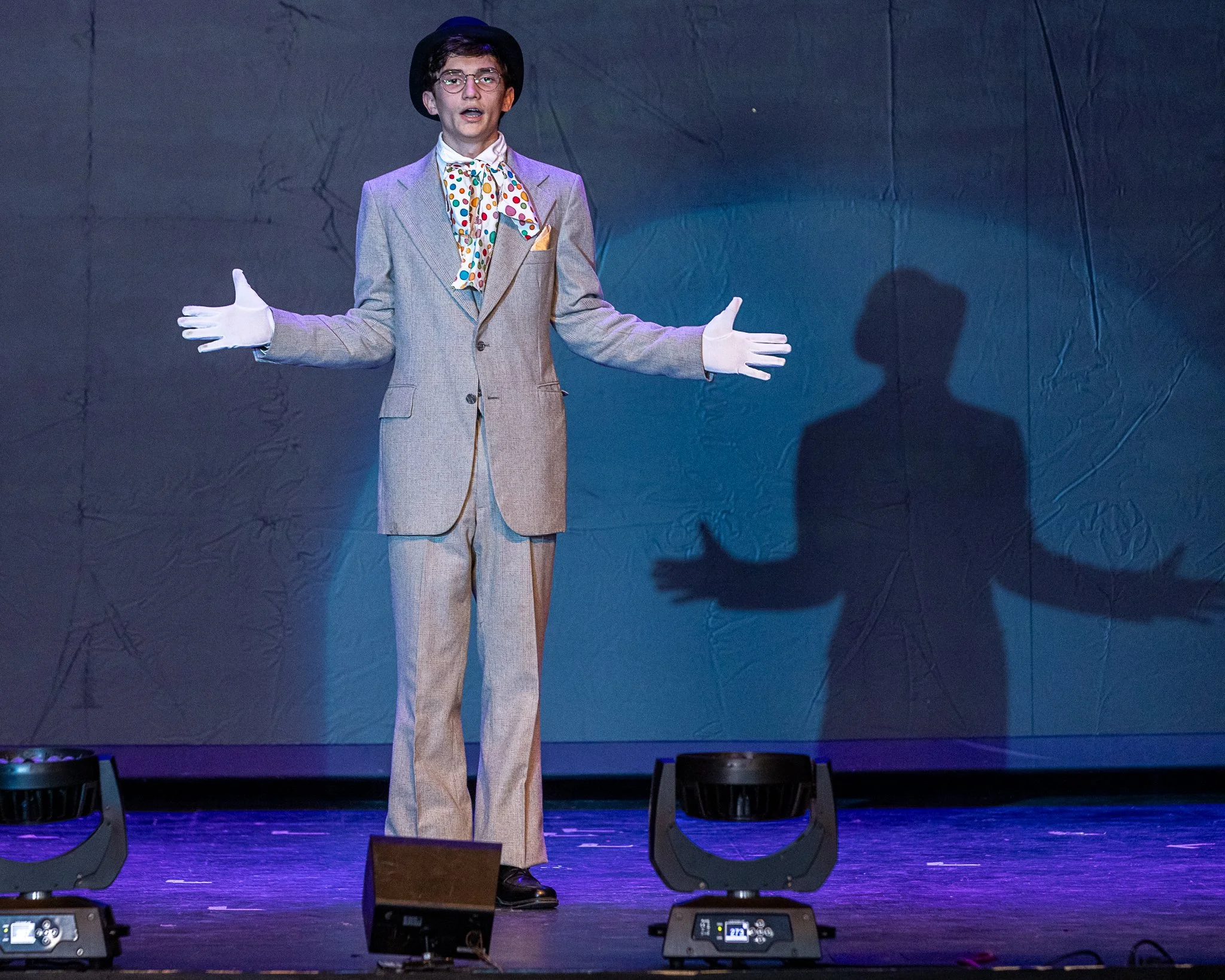 An actor stands on stage alone