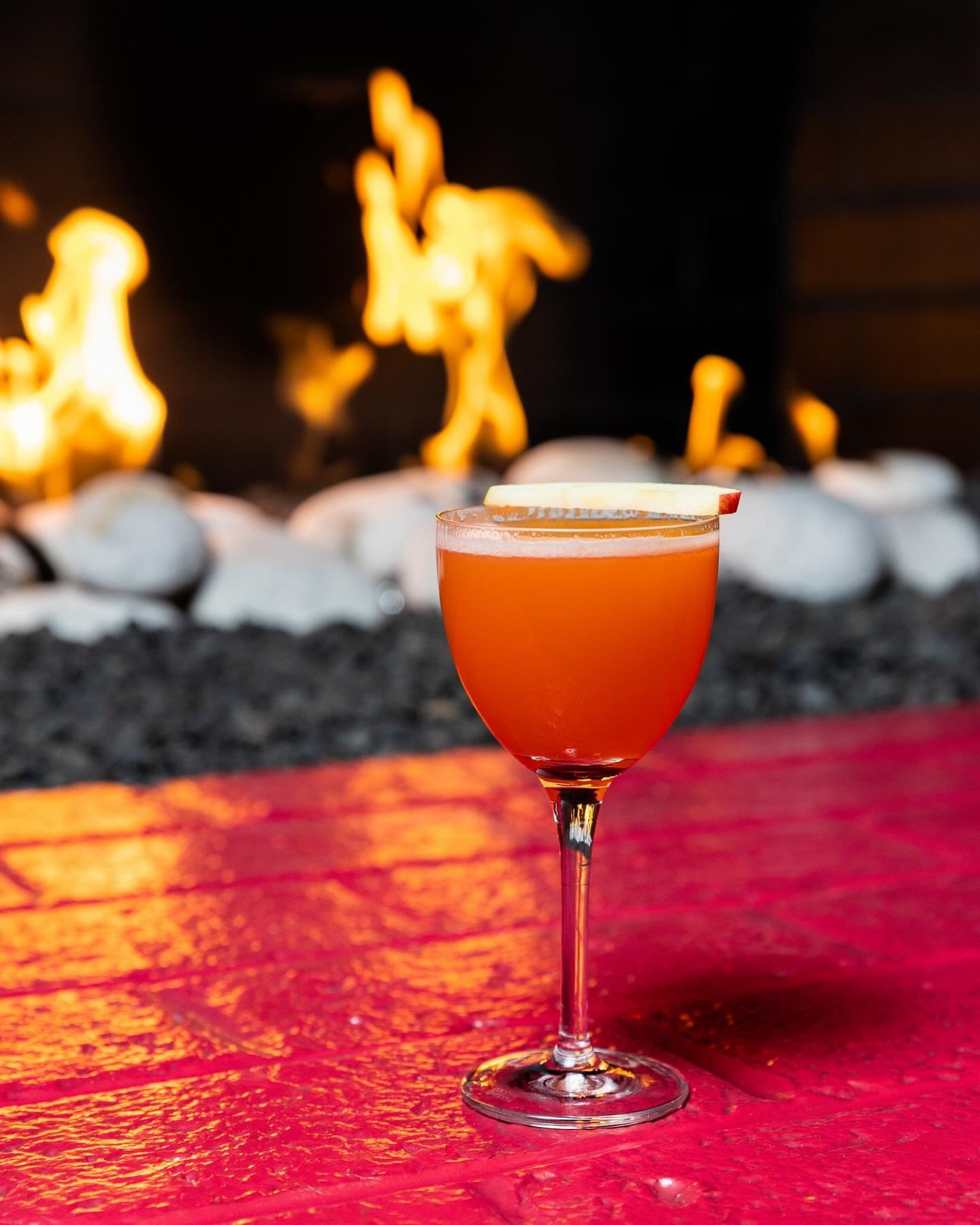Another perfect day to enjoy our fireplace with a cocktail in hand! 🔥 &ldquo;Apple Bottom Jeans&rdquo; featuring Apple brandy, aged brazilian rum, aperol, lemon, lime, turbinado, apple blossom. Cheers to the weekend! 

Be sure to check our website c