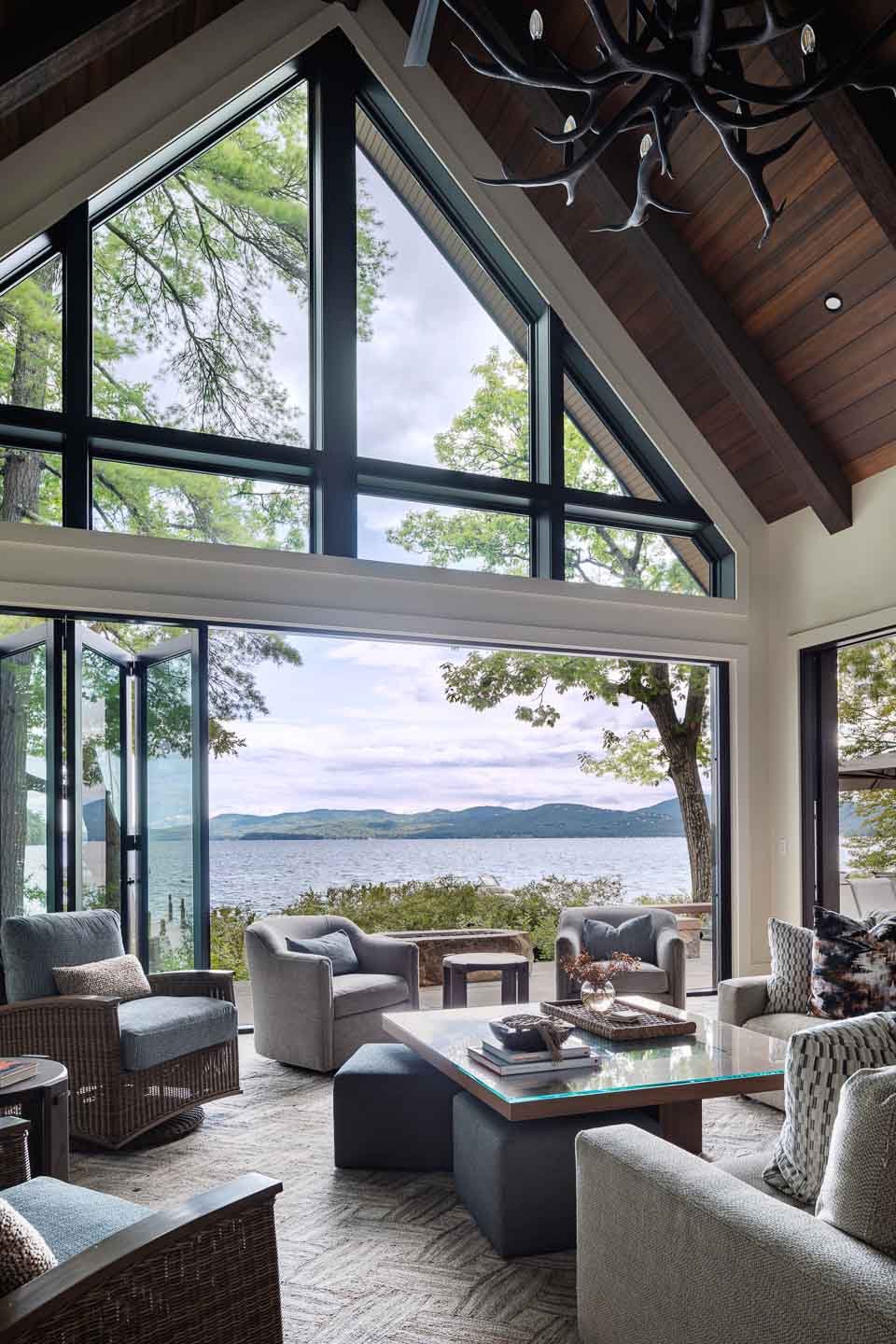 Indoor and outdoor space on this lakehouse built on Lake Winnipesaukee. Featuring relaxed seating and stunning views.| Lindsay Lawrence Interiors