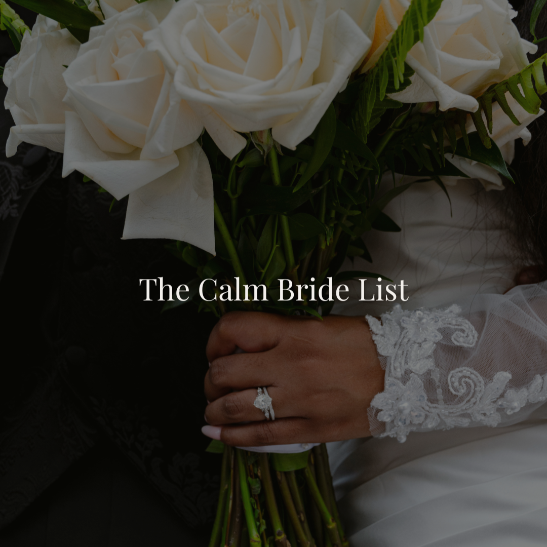 Close-up of a bride’s hand holding a bouquet of white roses, with a wedding ring visible on her finger, and lace detail on her sleeve, with the text 'The Calm Bride List' overlaid.
