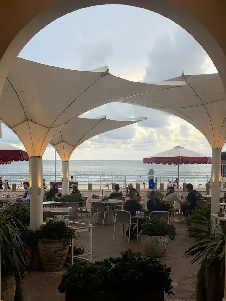 Front row to Bondi. Salt air and cold drinks just off the sand. 

Promenade Beach Bar is where you want to stay.