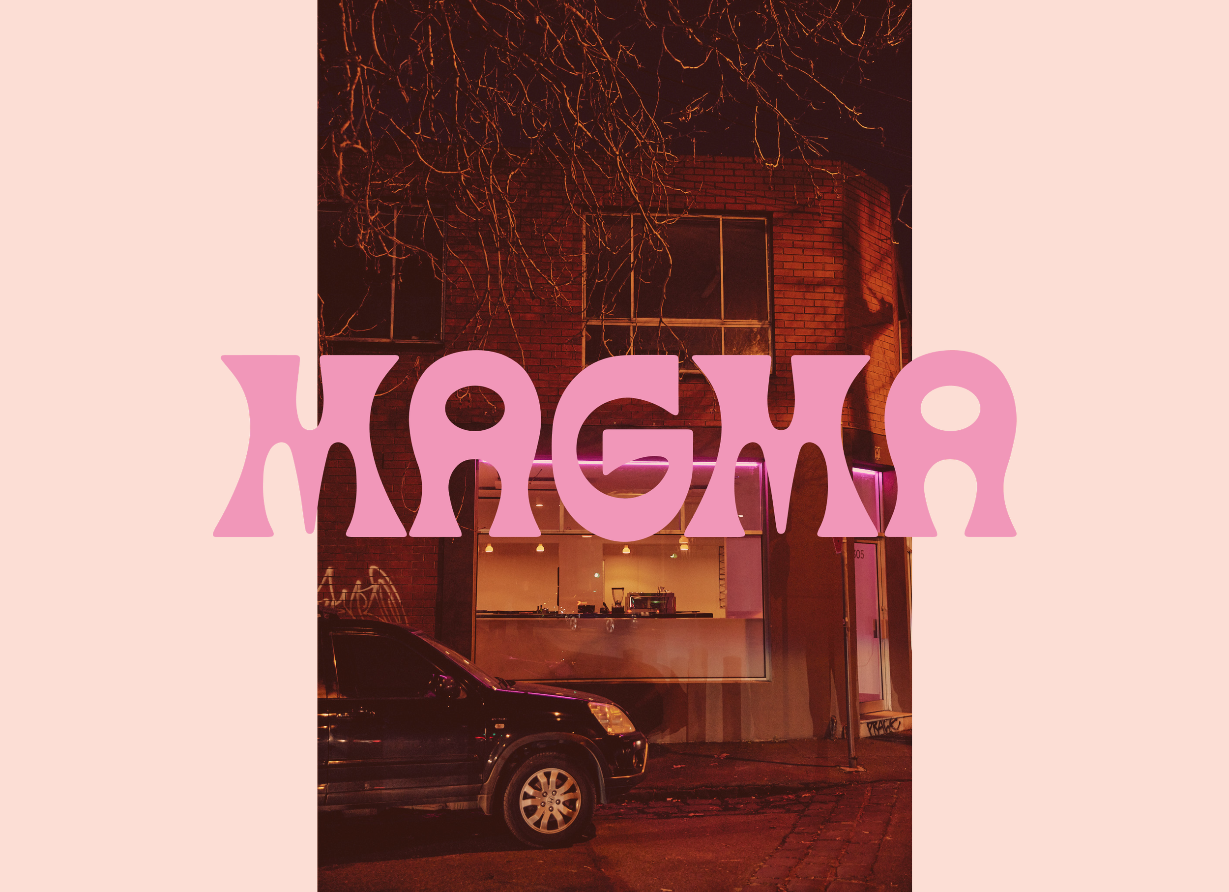 Nighttime scene of the Pizzera Magma exterior with large glass windows, a parked black car in front, and leafless tree branches overhead, with warm lighting inside creating a cozy atmosphere, with pink text overlay that reads "Magma"