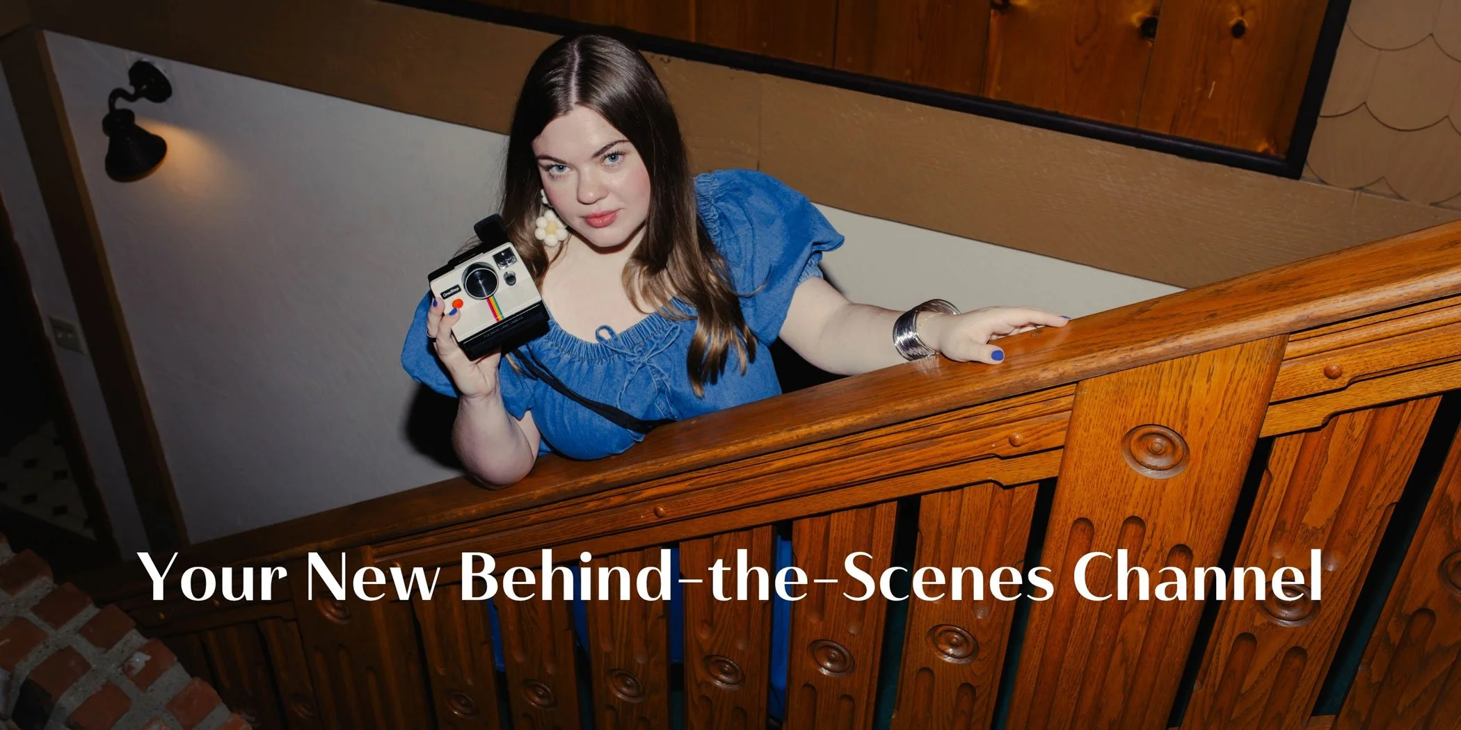 Woman holding a camera creating behind-the-scenes Instagram content for brands
