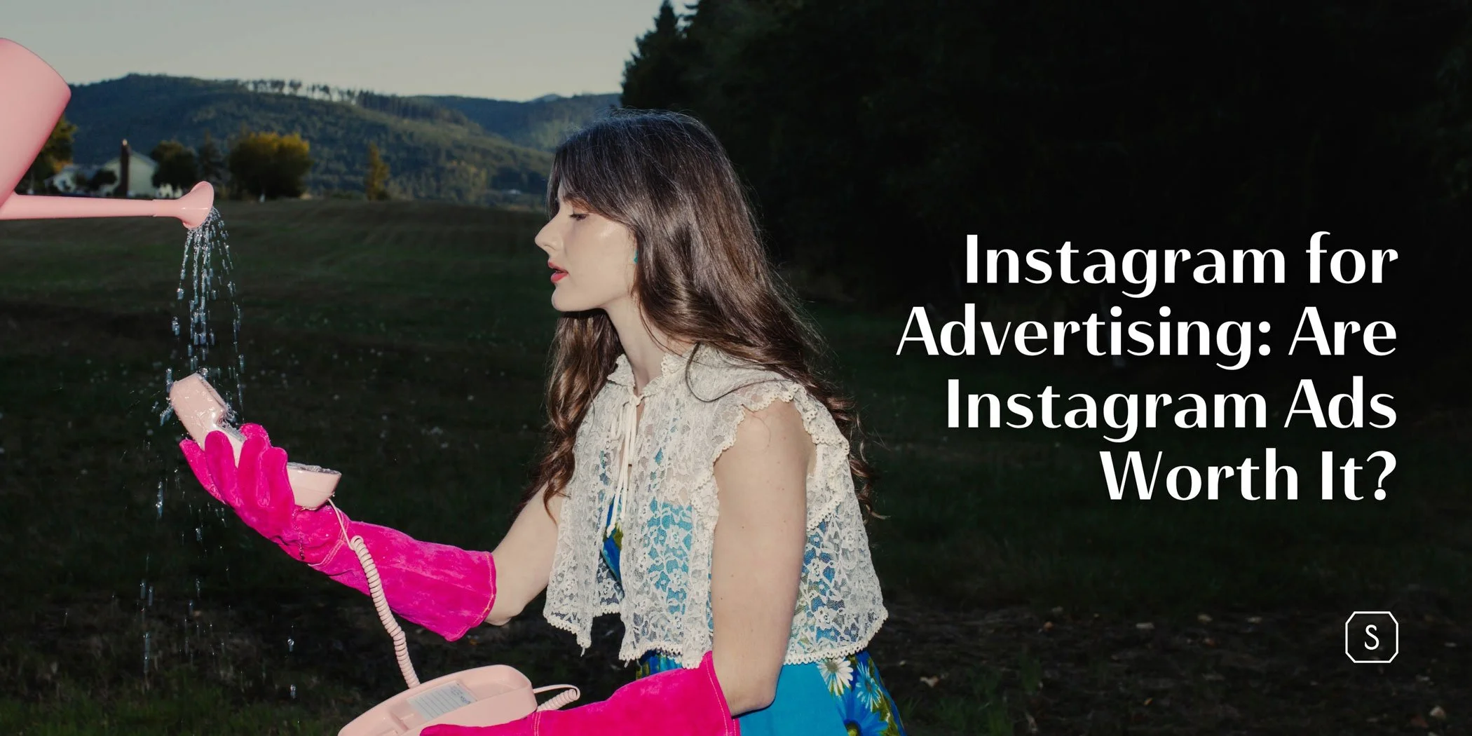 Woman holding a pink phone under a watering can outdoors, creative concept for Instagram for advertising and digital growth