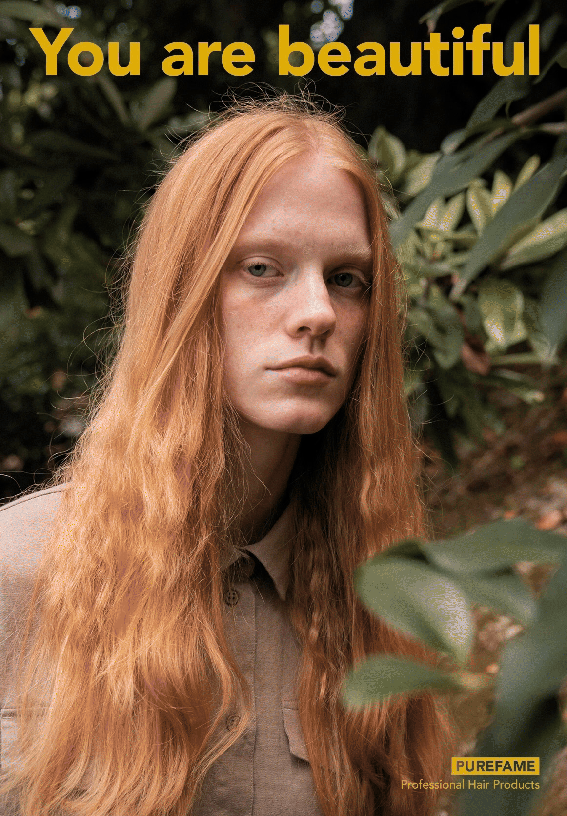 Eine Person mit langen, roten Haaren in der Natur, umgeben von grünen Blättern. Im Bild steht oben "You are beautiful" und unten das Logo von PUREFAME mit dem Text "Professional Hair Products".