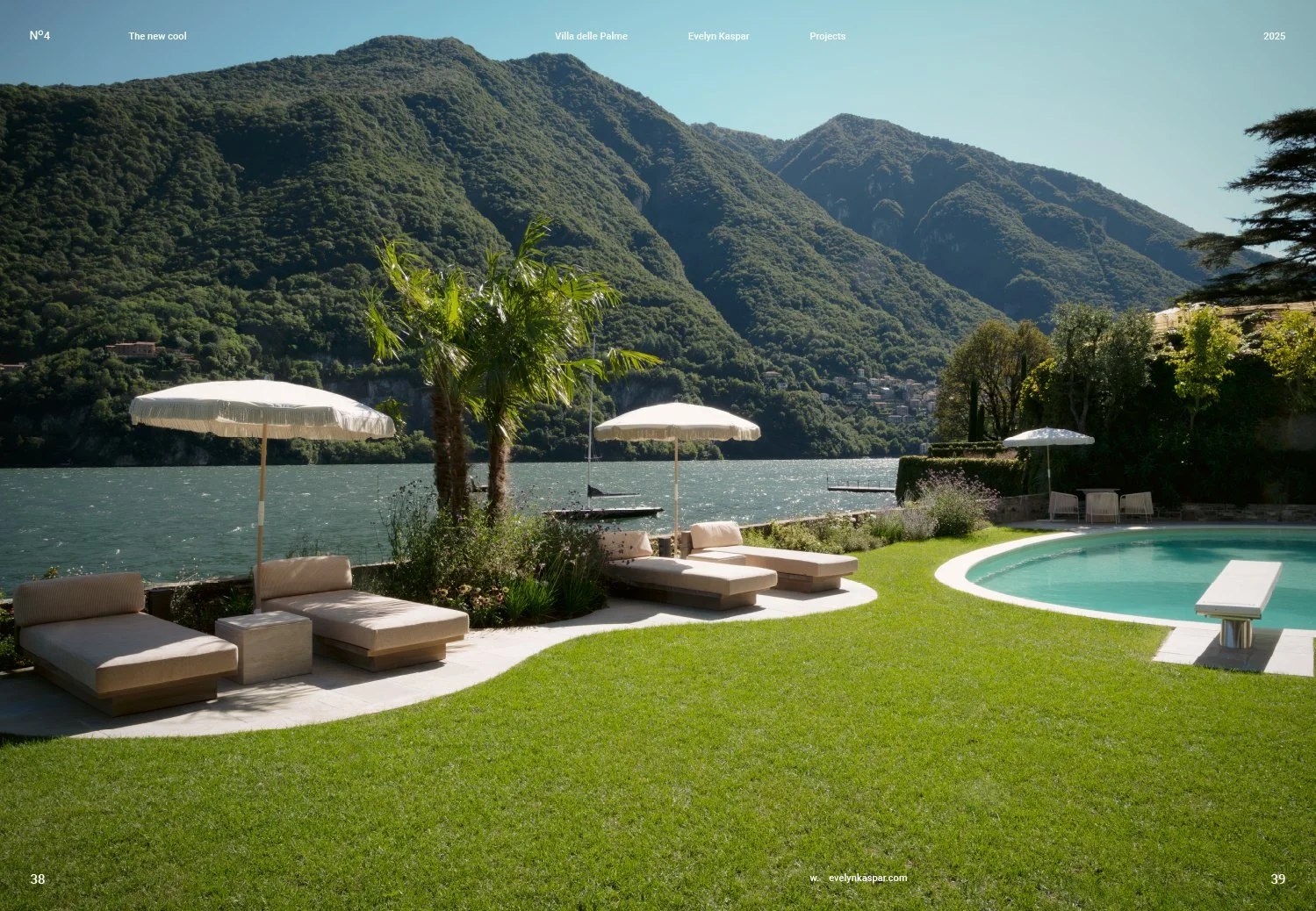Luxurious outdoor poolside area with lounge chairs, umbrellas, and a lush green lawn overlooking a lake and mountains in the background.