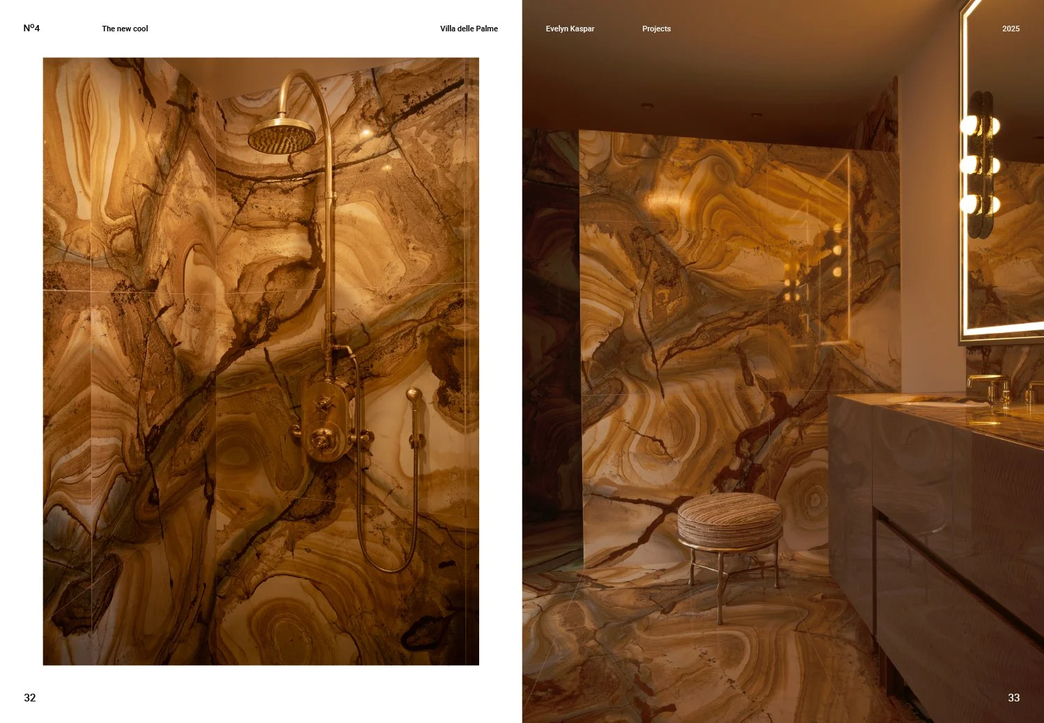 A luxurious bathroom featuring walls and floors made of polished, brown, gold, and cream marble with intricate veining, including a walk-in shower with a gold showerhead and fixtures on the left page, and a vanity area with illuminated mirror, sink, 