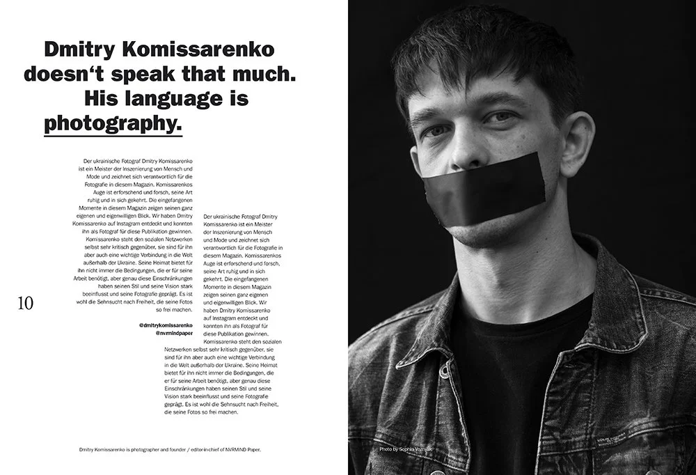 A magazine spread featuring a black-and-white portrait of a young man with short dark hair, wearing a denim jacket and black shirt, with black tape covering his mouth. The text on the left side discusses Ukrainian photographer Dmitry Komissarenko and