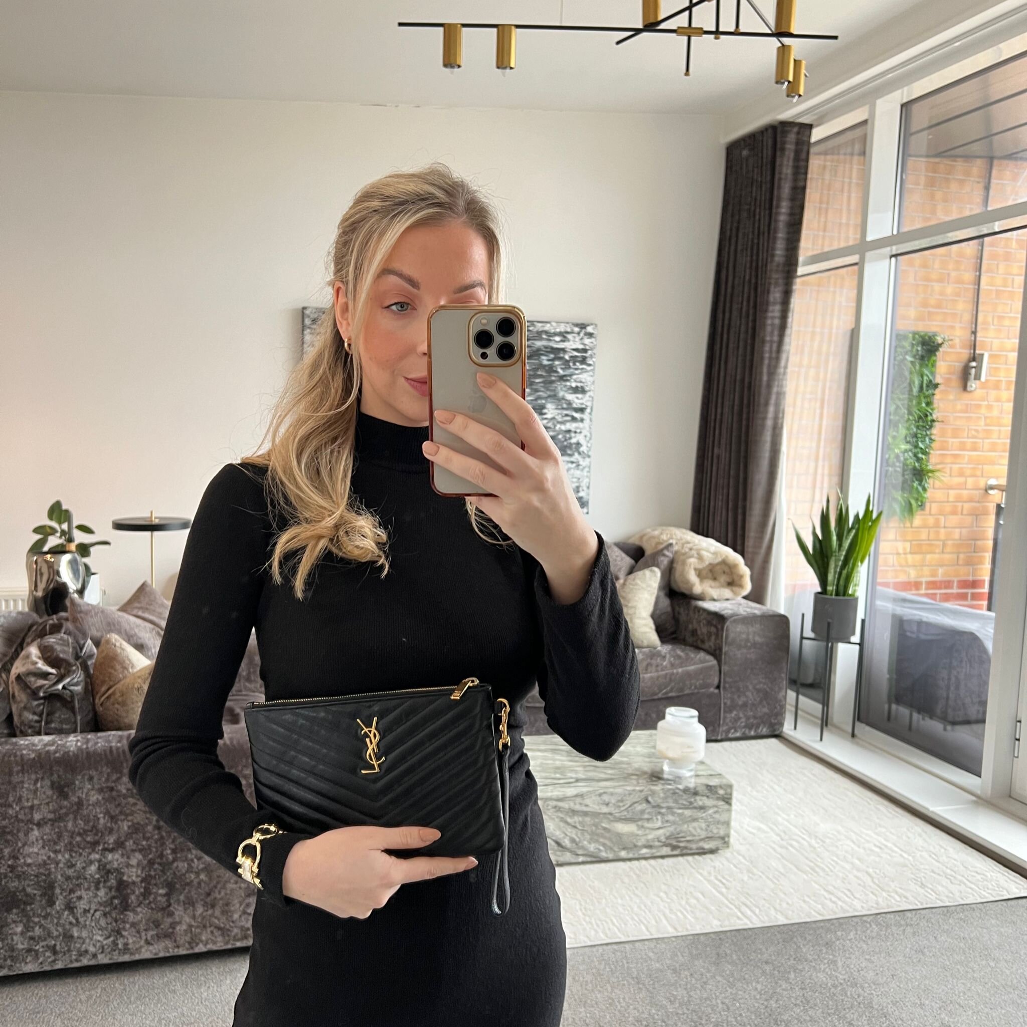 Saint Laurent YSL Quilted Monogram Pouch Clutch Bag in Black with Gold Hardware shown on model