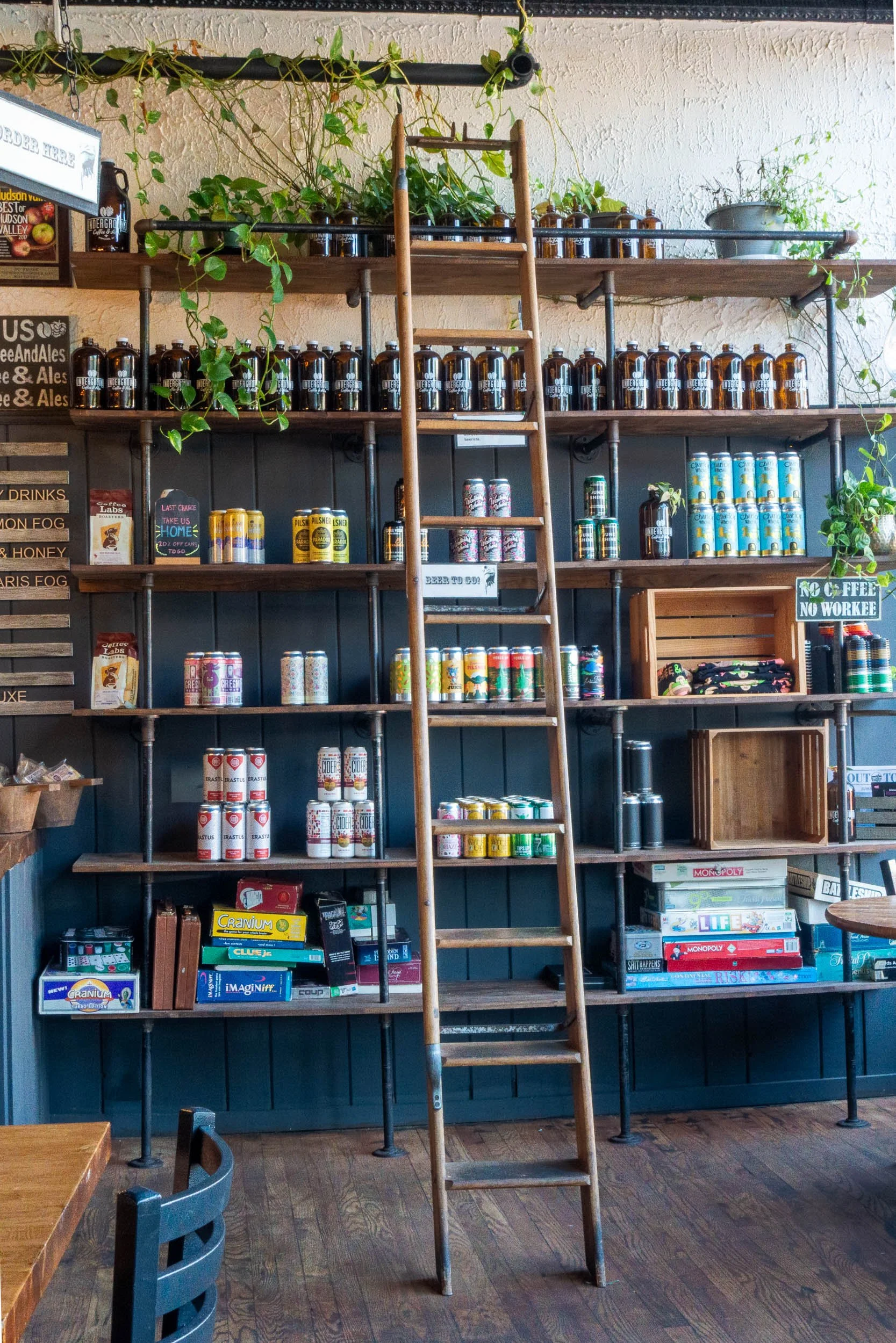 A ladder in front of shelves filled with cans and jars