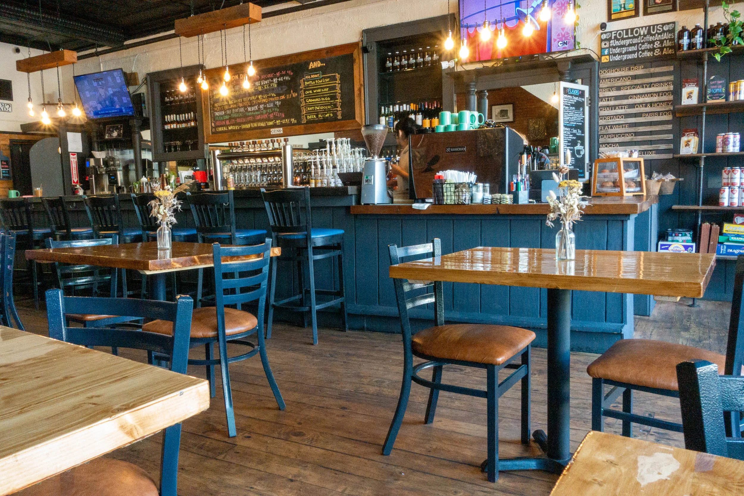 Tables and chairs with the counter and bar in the background